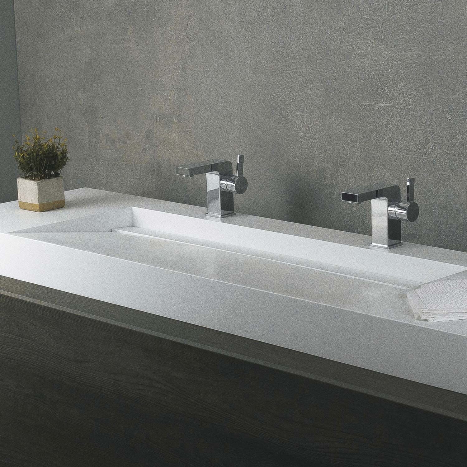 Modern white double basin sink with polished chrome faucets and concrete wall