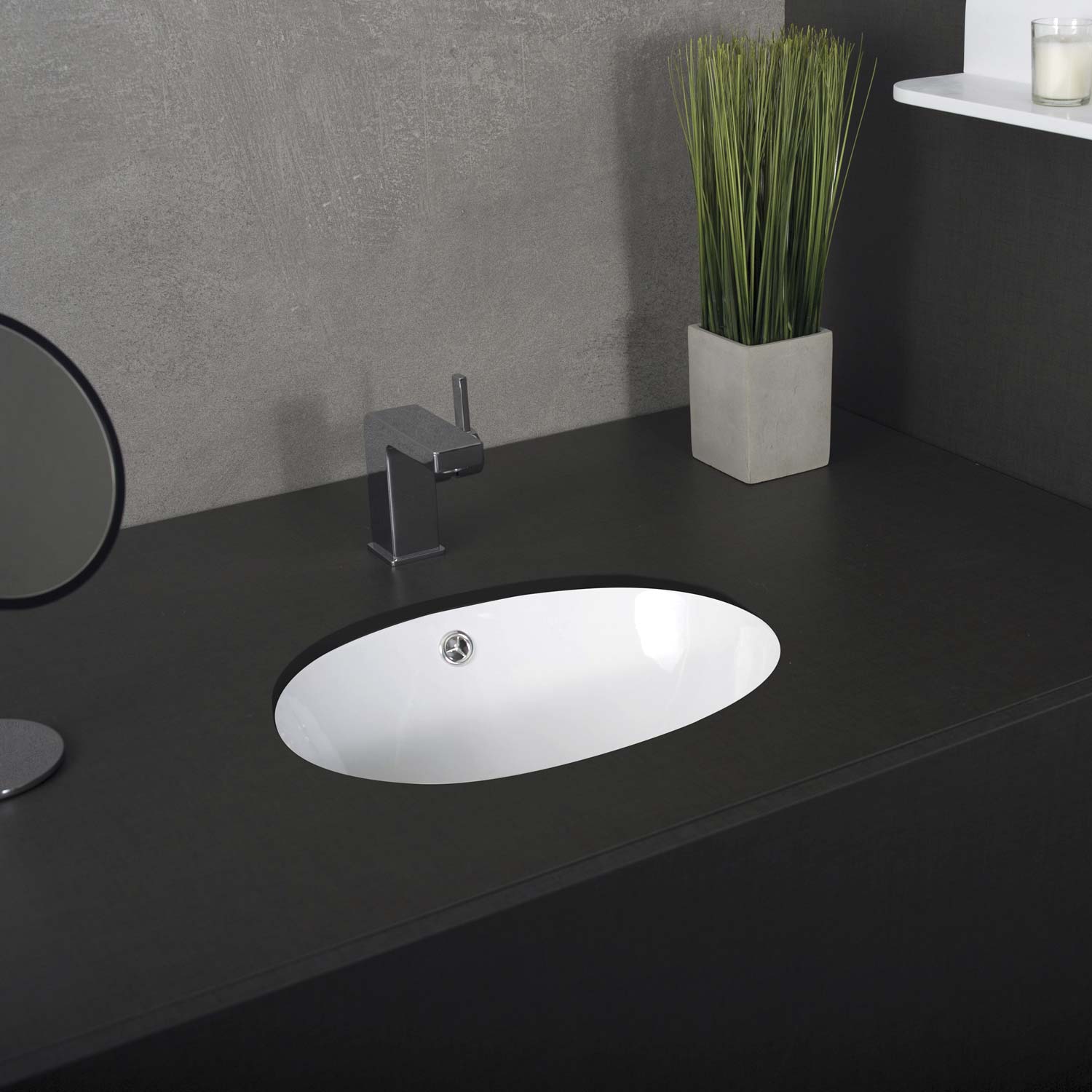Modern oval white undermount bathroom sink with chrome faucet