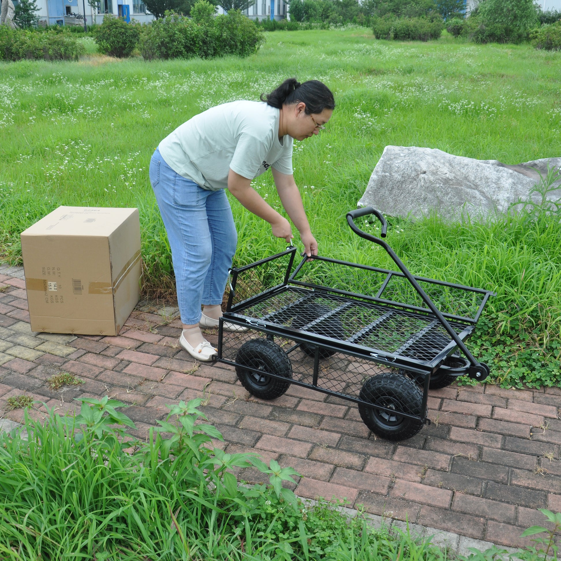 Black steel garden wagon with four wheels for hauling supplies
