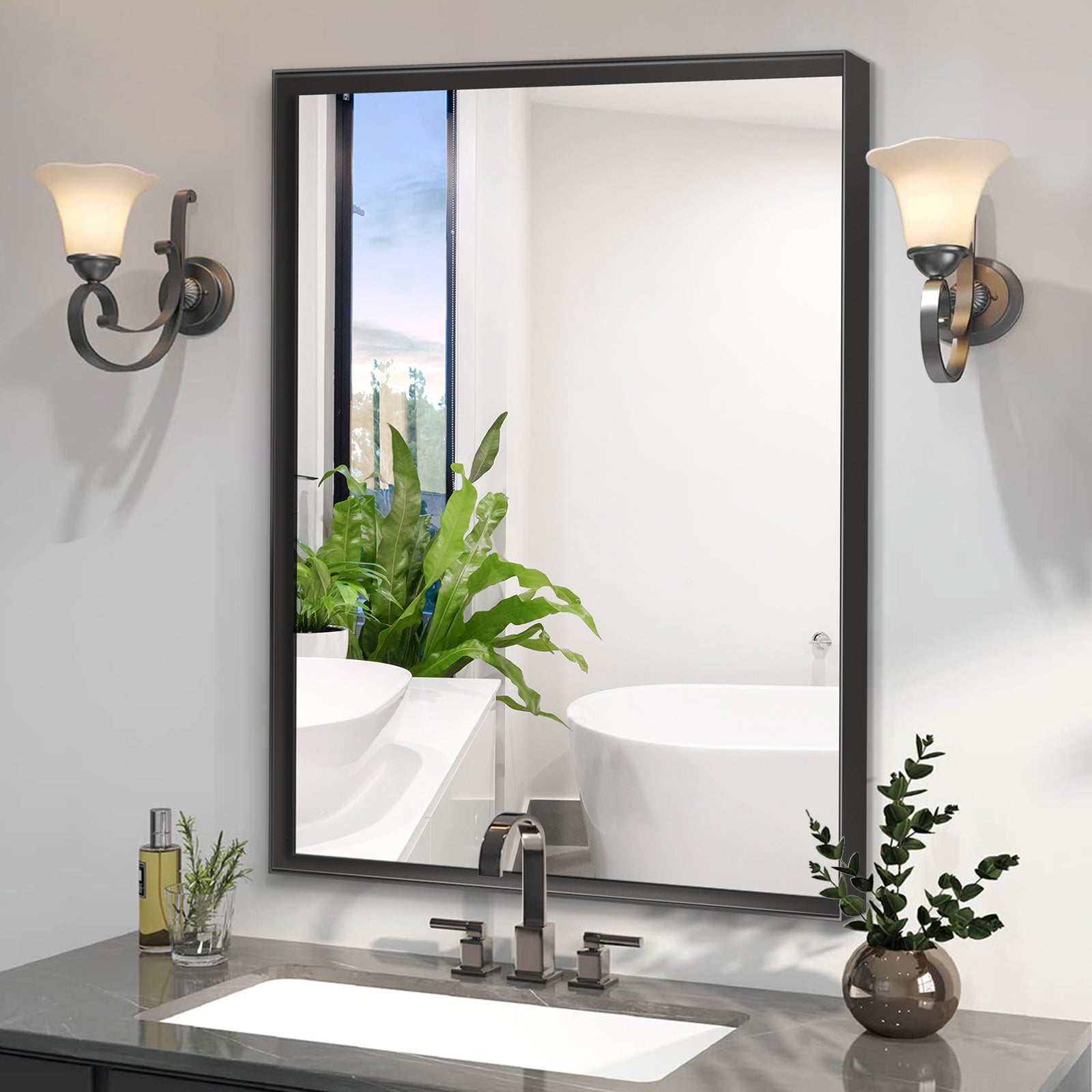 Modern black framed bathroom mirror with brushed nickel faucet and white vanity