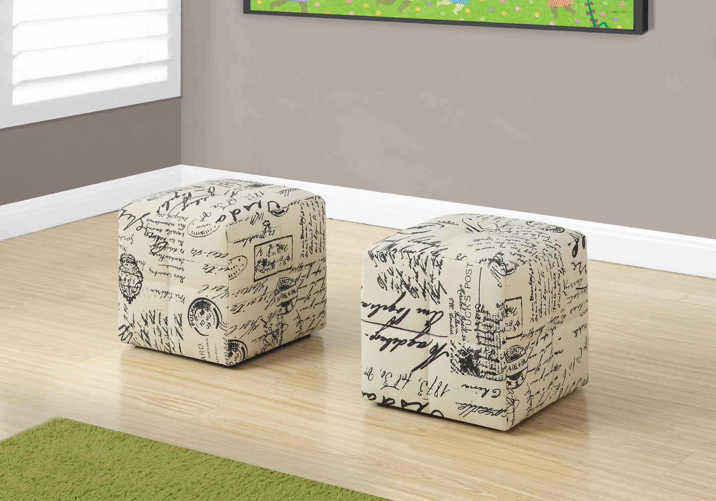 Beige upholstered ottoman with vintage script print and accent stamps perfect for footrest