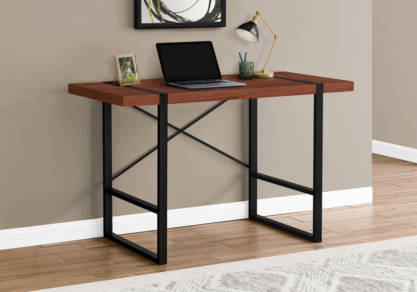 Modern walnut wood desk with black metal frame laptop and lamp