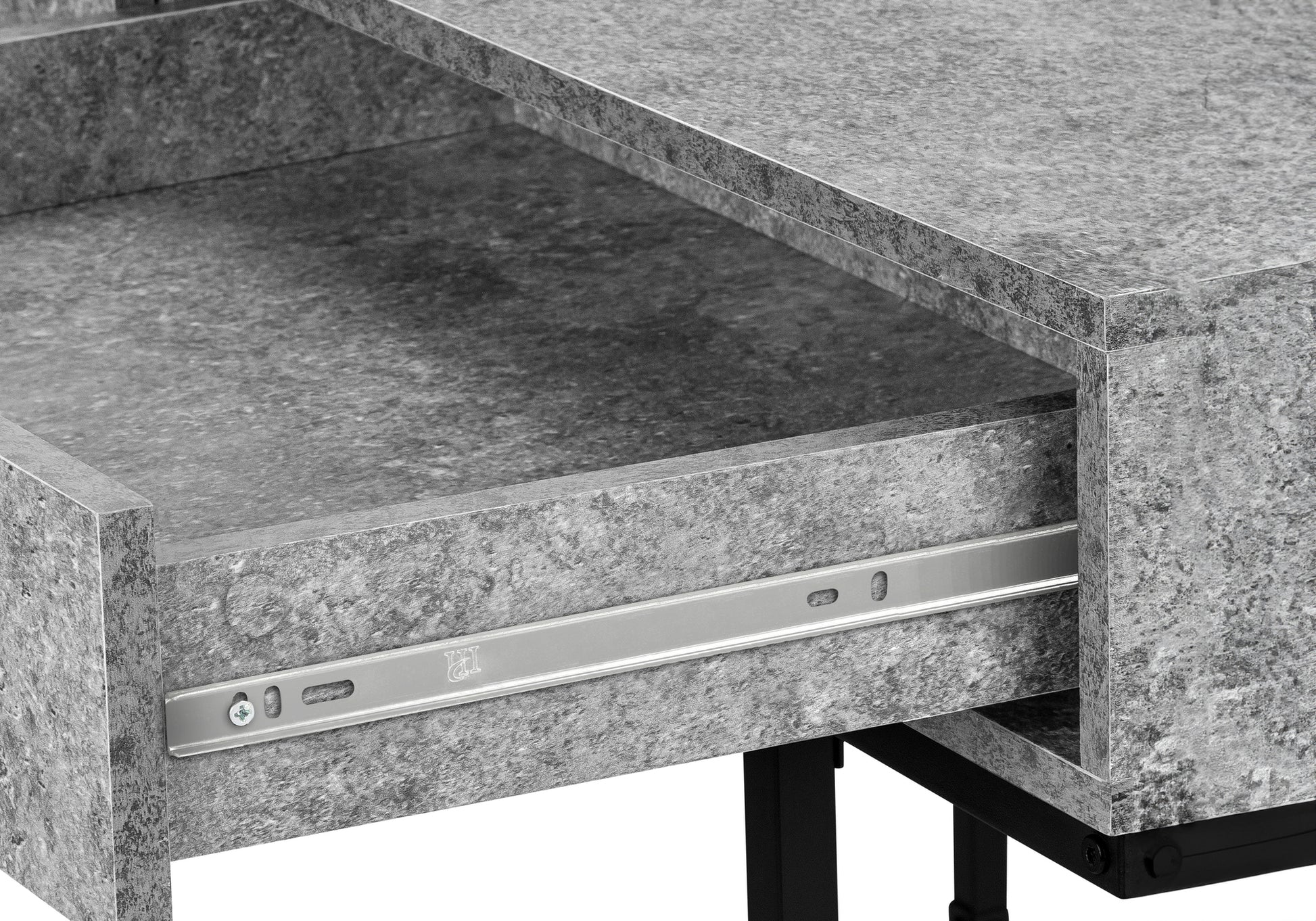 Close up of a gray stoneeffect drawer with metal slides on a modern desk