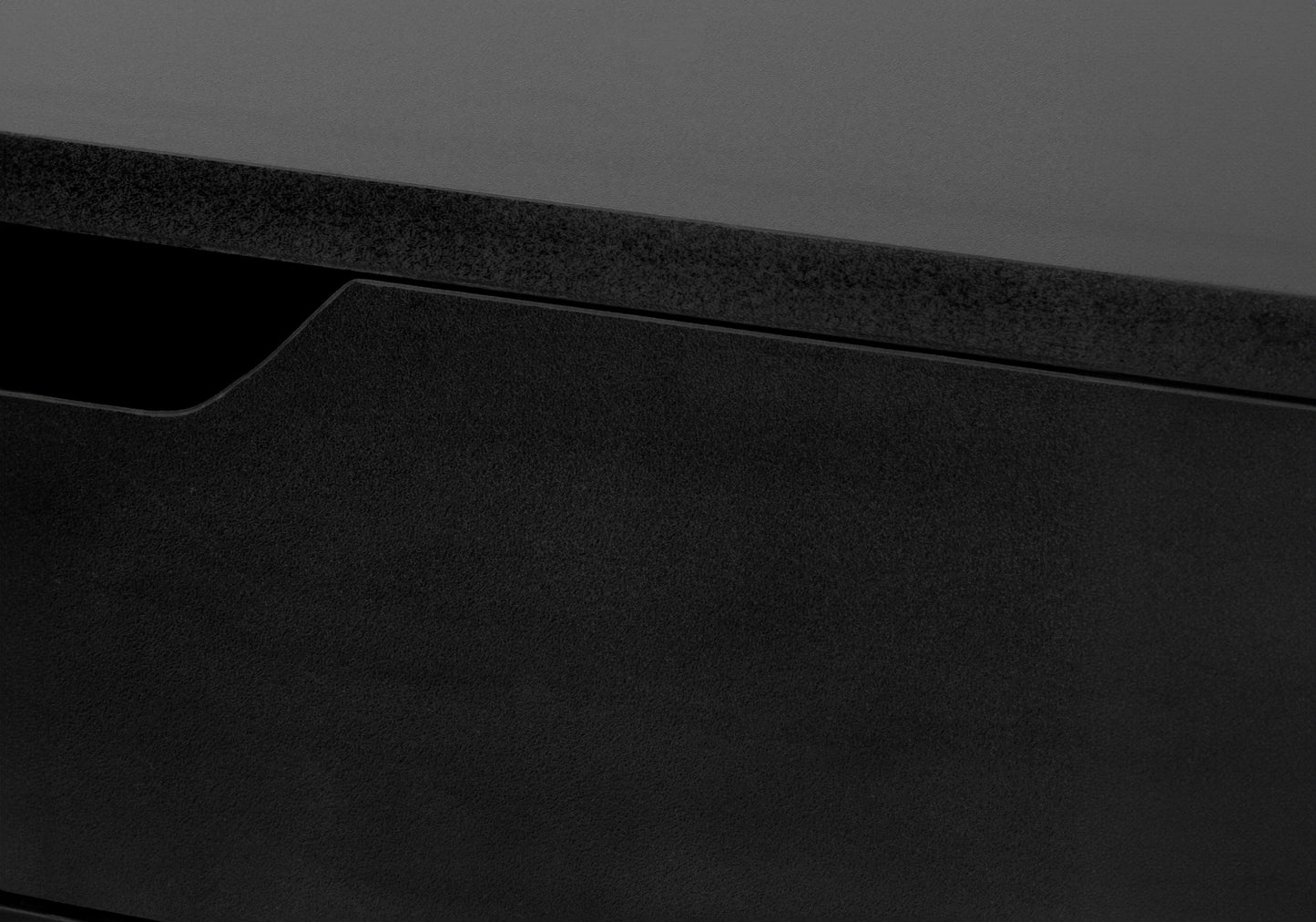 Black textured desk drawer with subtle indent for grip