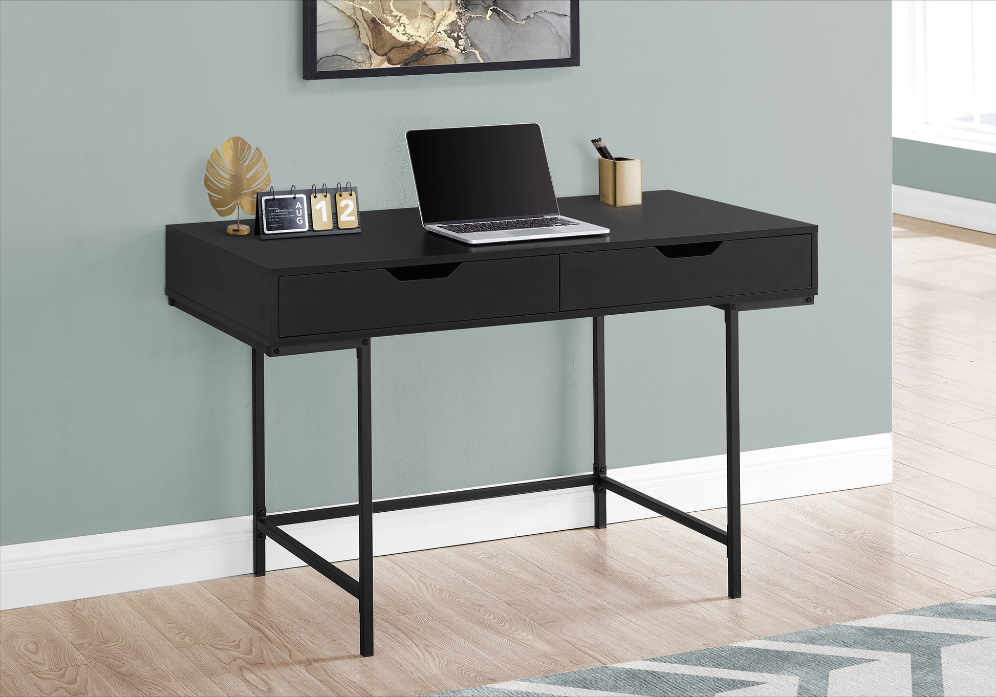 Sleek black minimalist desk with two drawers metal legs and laptop setup for a home office