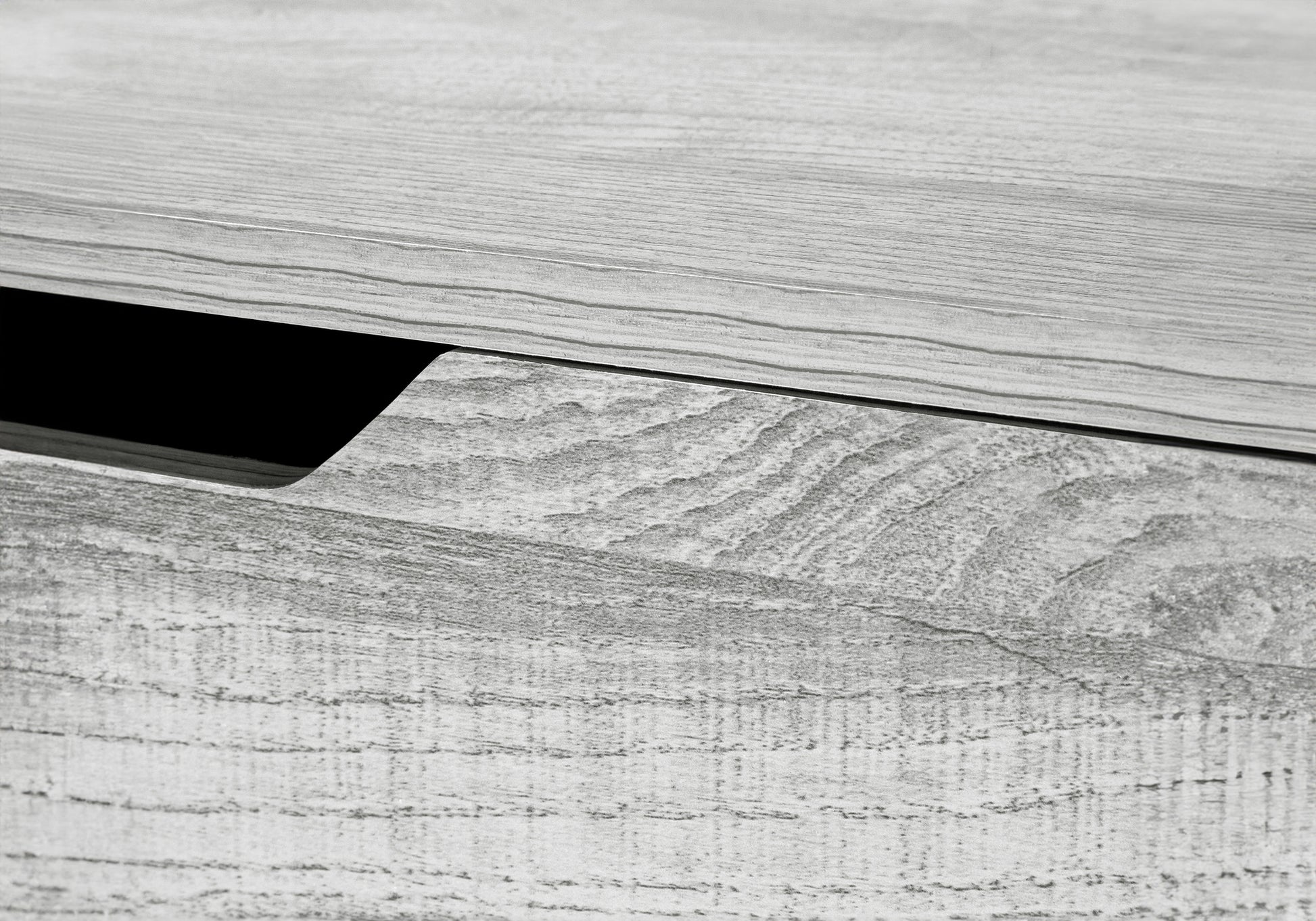 Closeup of a weathered grey wood grain texture with a subtle opening