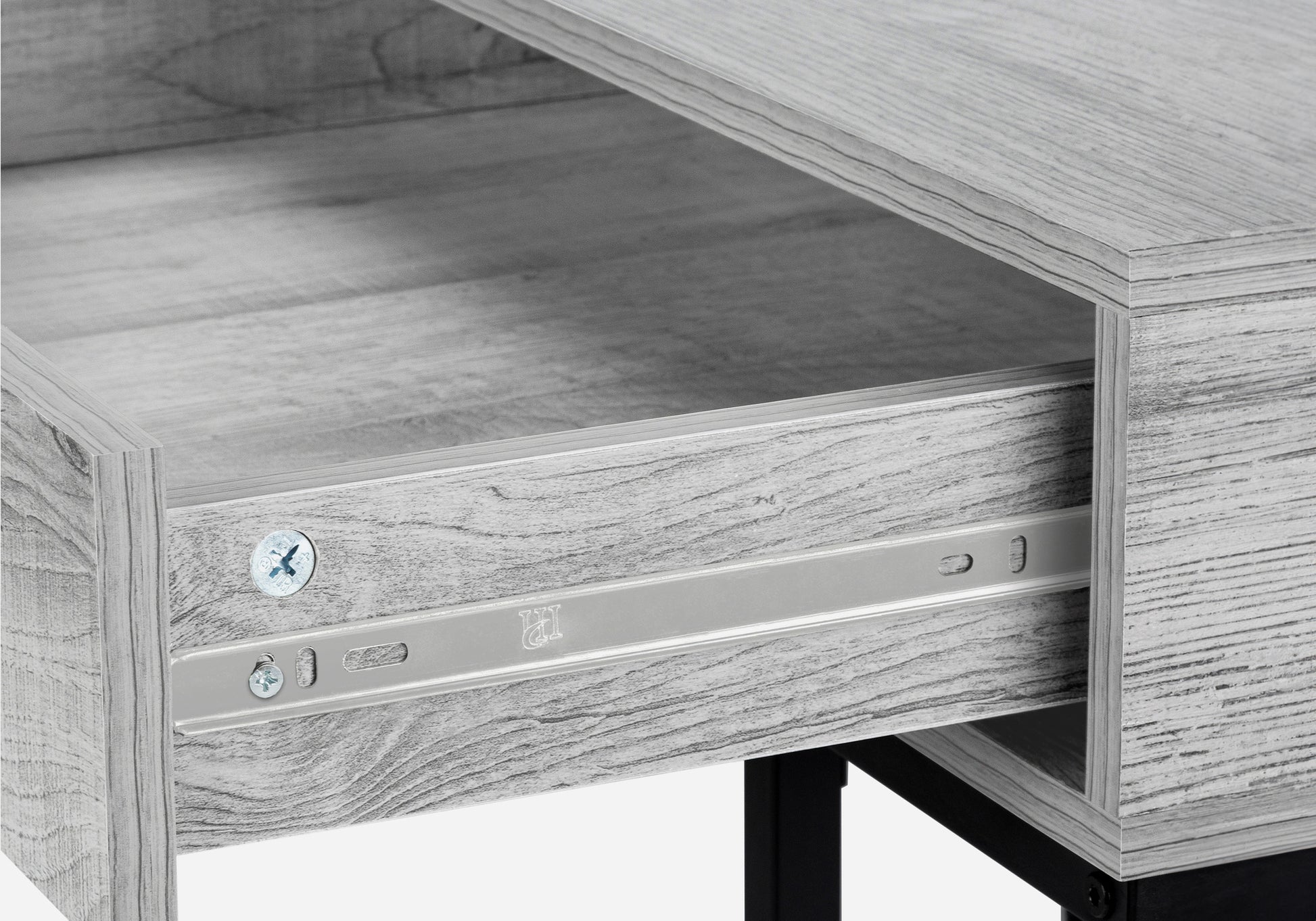 Closeup of light grey wood grain desk drawer with metal slide