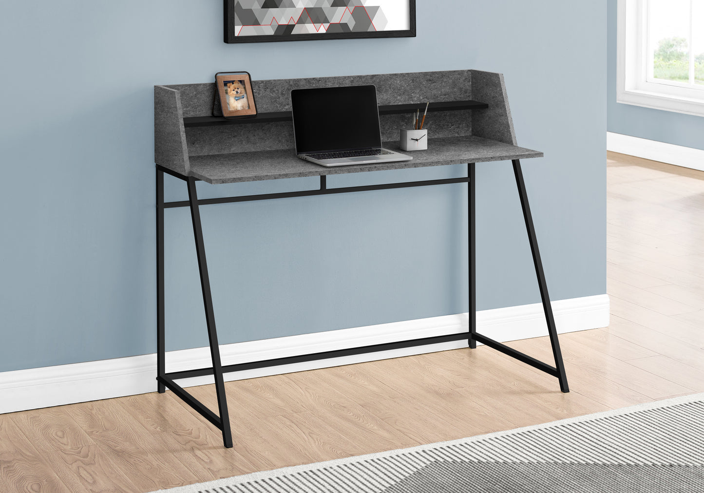 Modern grey particle board desk with black metal legs and open shelving for home office