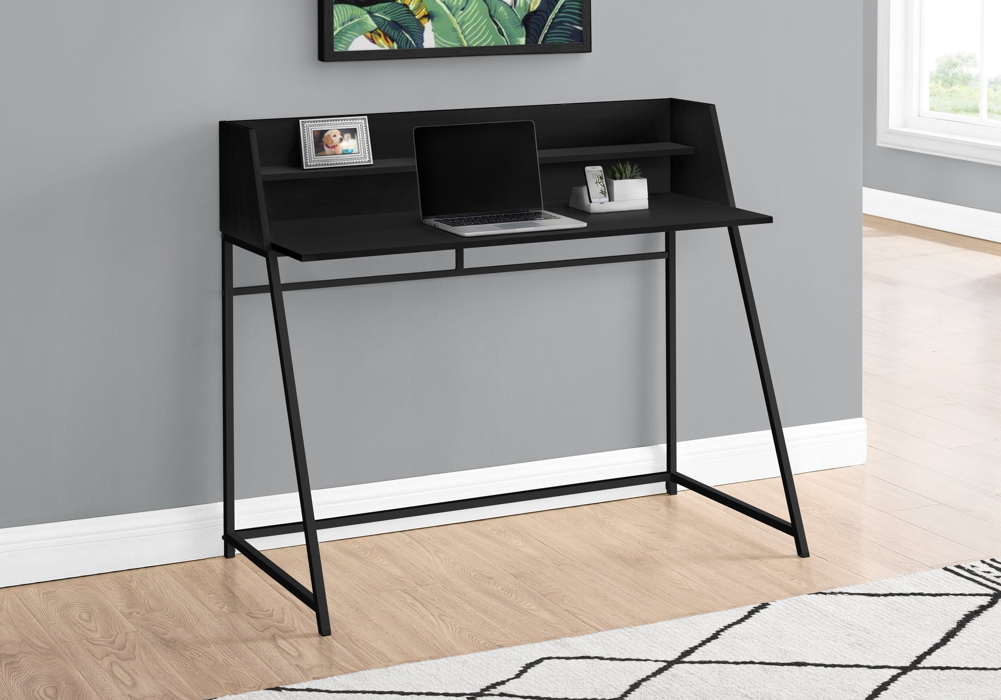 Sleek black metal frame writing desk with upper shelf and laptop for home office