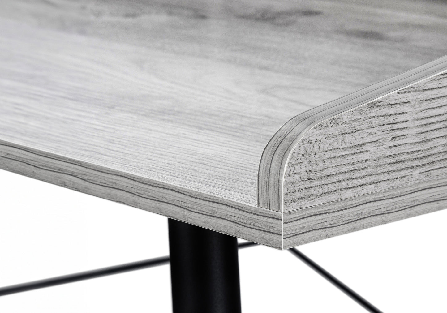 Closeup of a light gray wood grain desk surface with a rounded edge detail