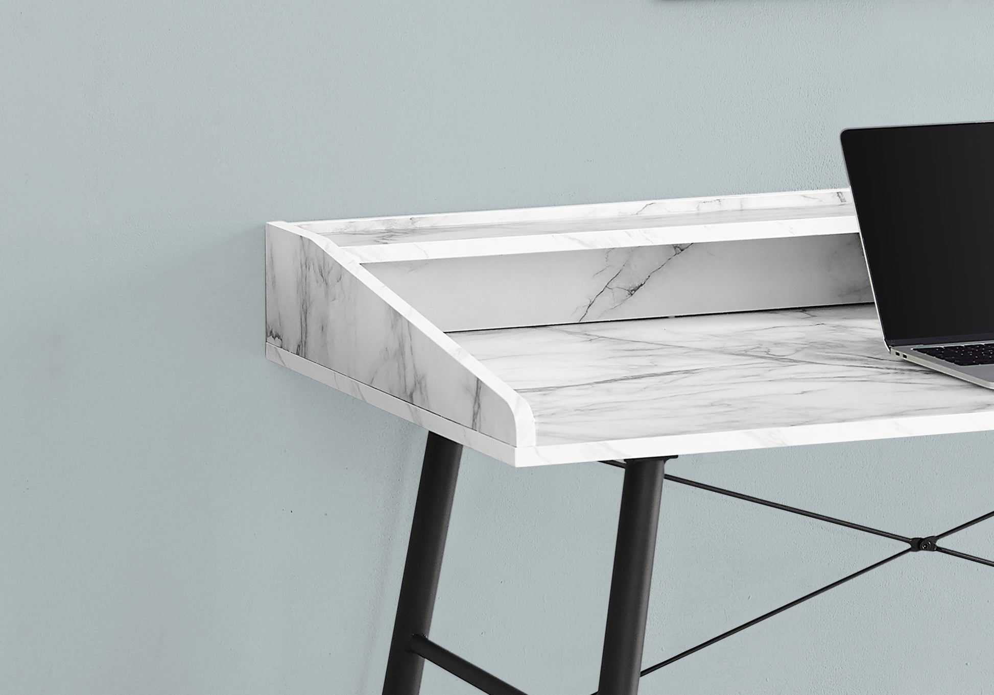 Modern white marble desk with black legs and a builtin shelf for a laptop