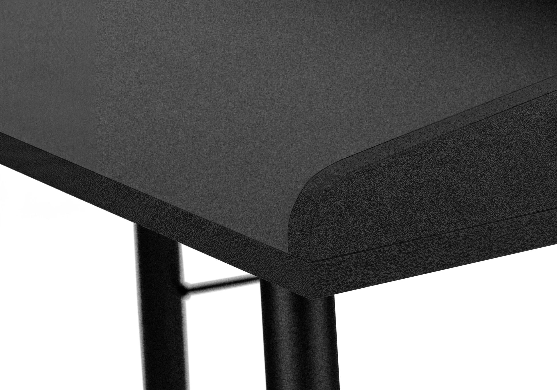 Black textured tabletop with rounded corner part of a modern desk