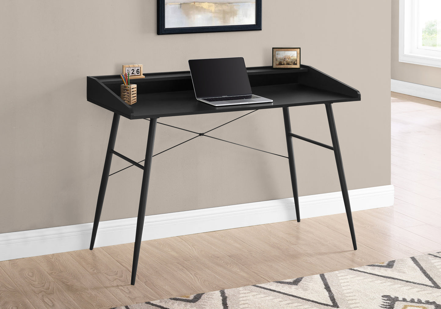 Sleek black writing desk with a modern design and minimalist steel legs perfect for home offices