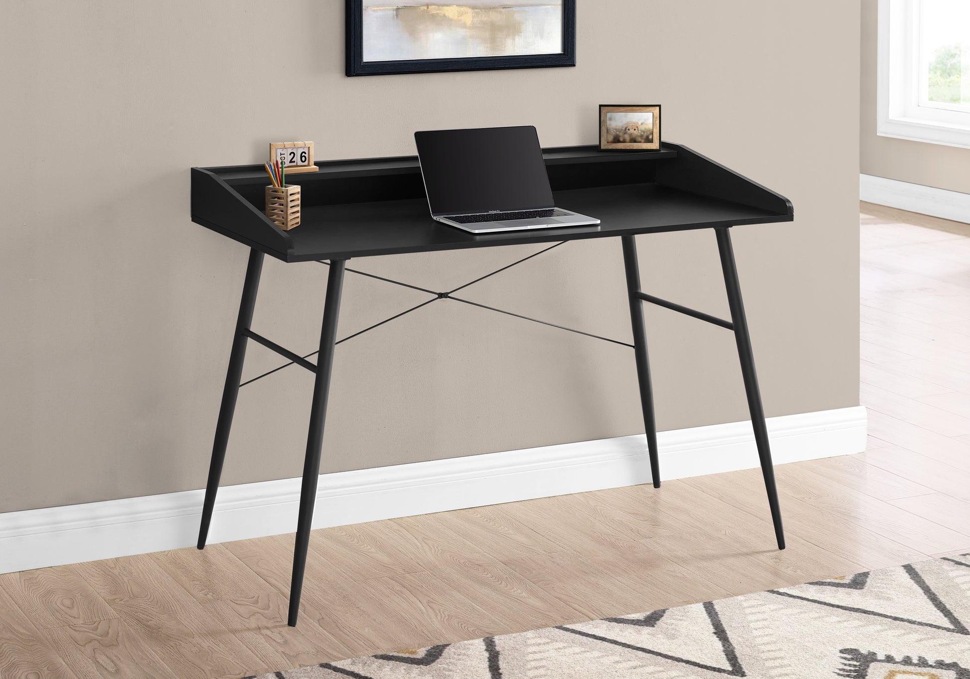 Sleek black writing desk with a modern design and minimalist steel legs perfect for home offices