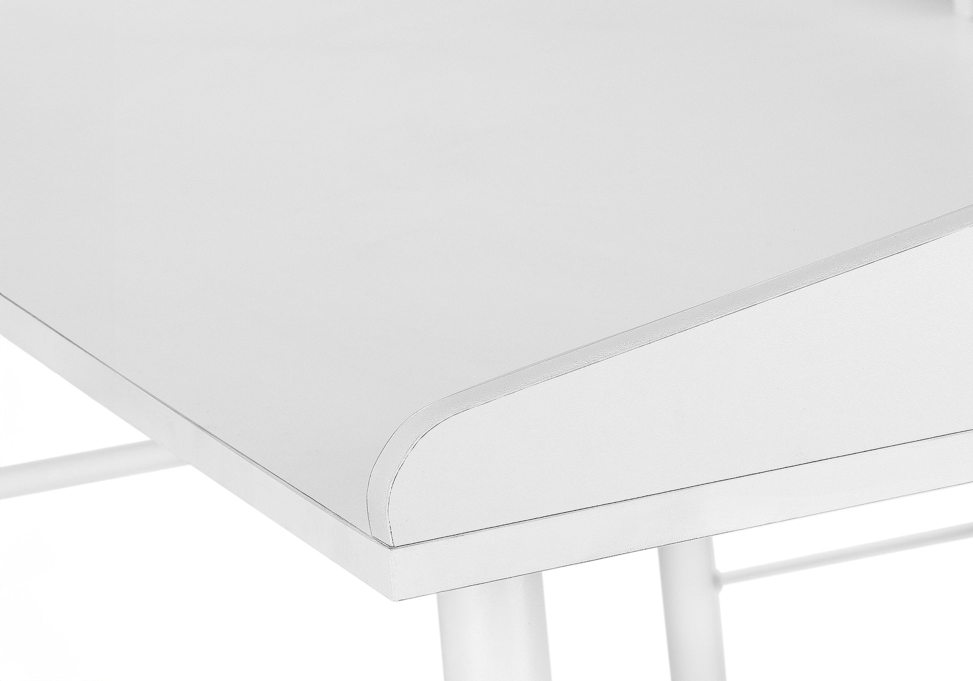 Closeup of a modern white desk surface with a rounded edge perfect for any home office setup