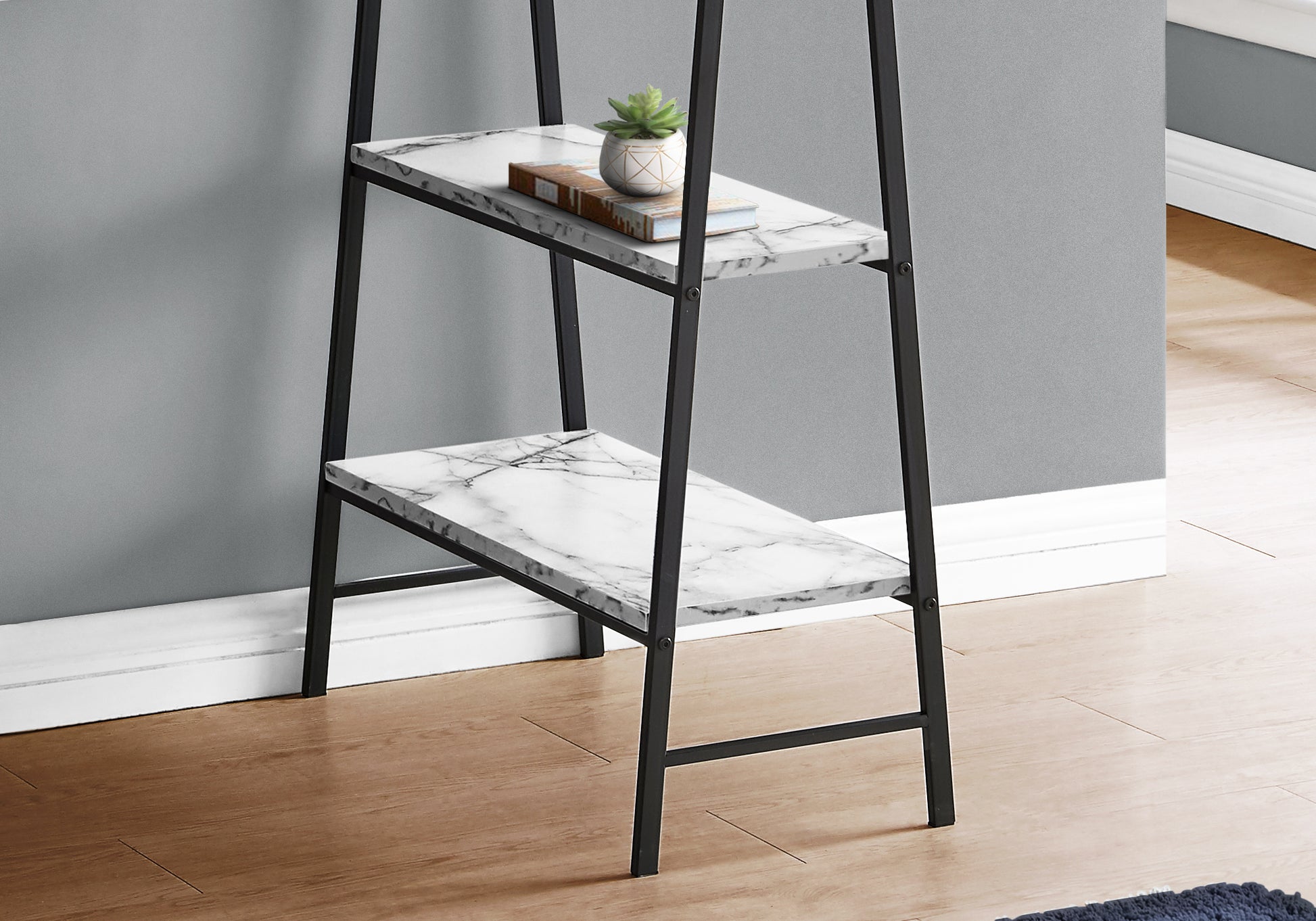 Black metal frame leaning bookshelf with white marble pattern shelves