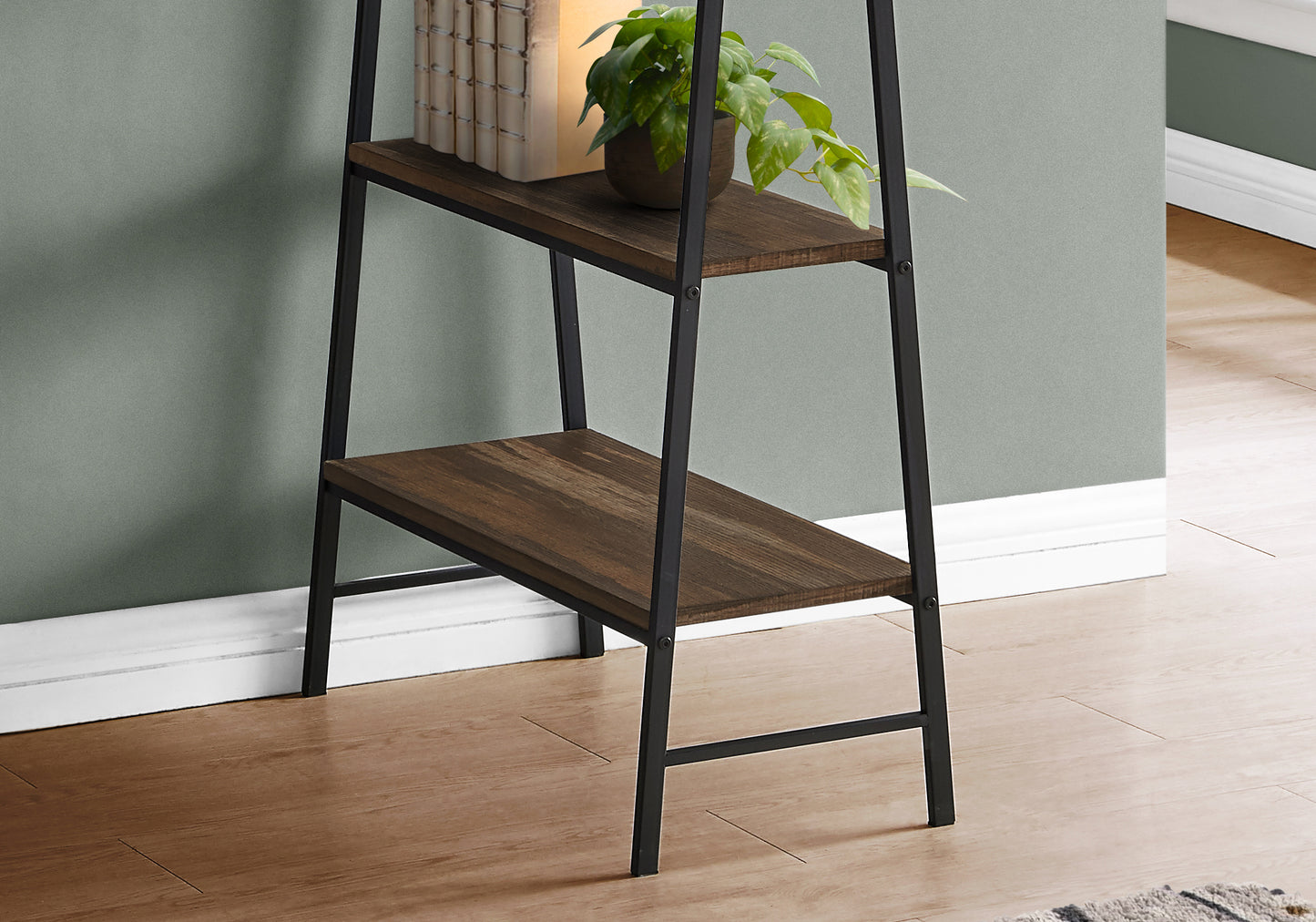 Rustic wood and black metal ladder shelf with decorative plant