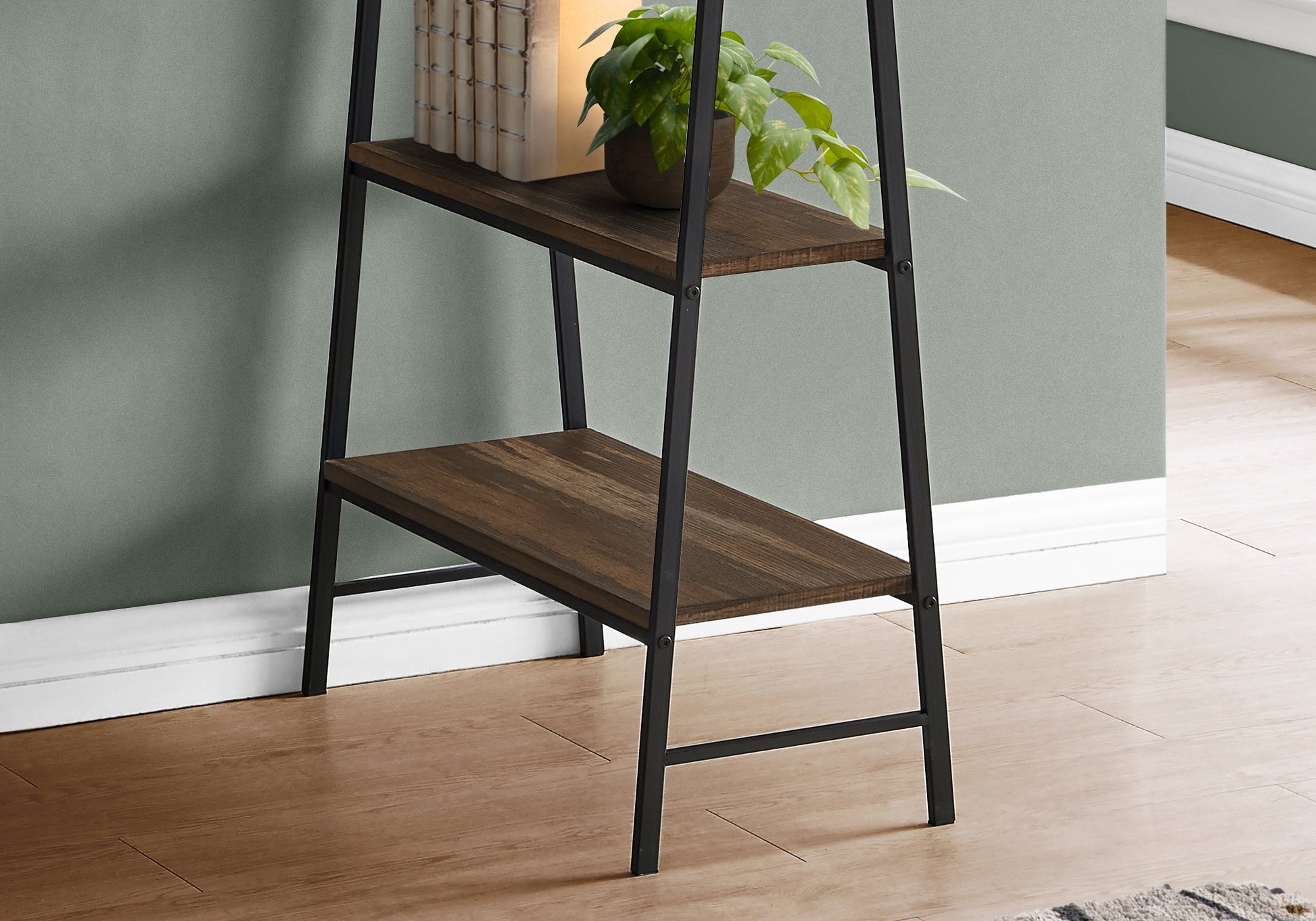 Rustic wood and black metal ladder shelf with decorative plant