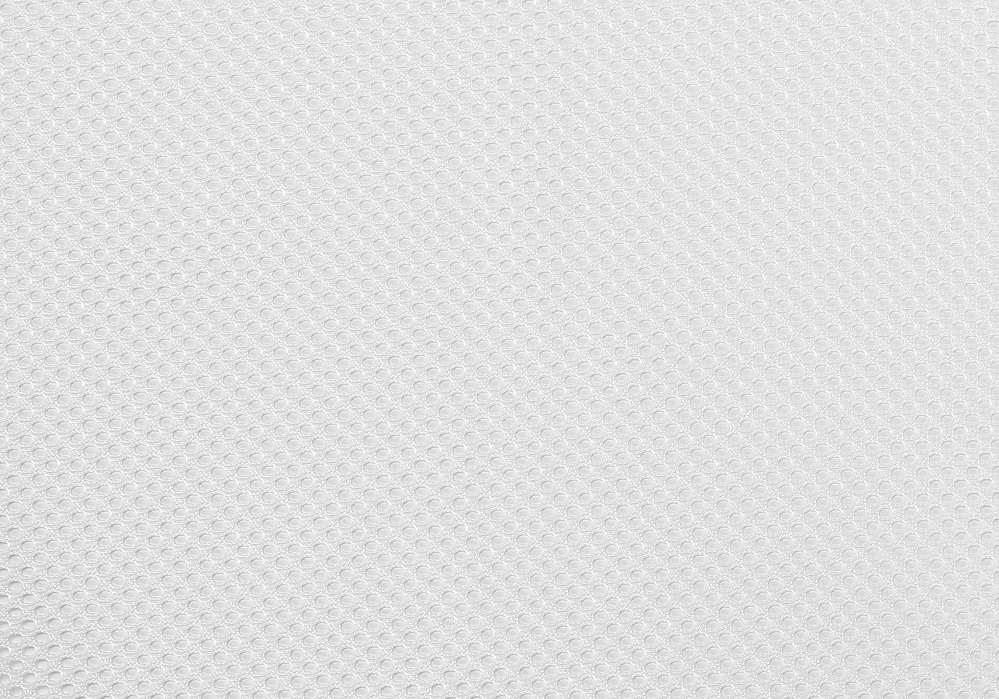 White textured fabric with small evenly spaced circular patterns