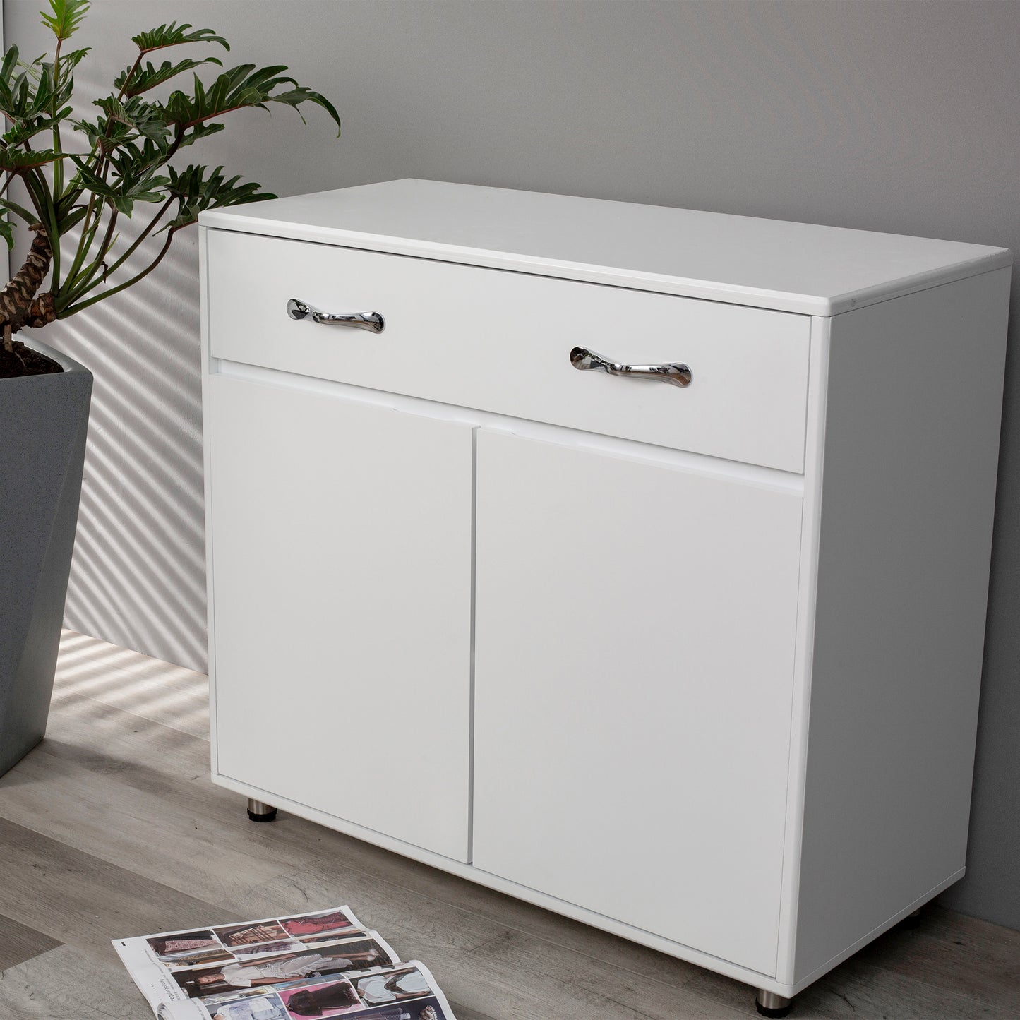 White twodoor cabinet with one drawer and chrome handles