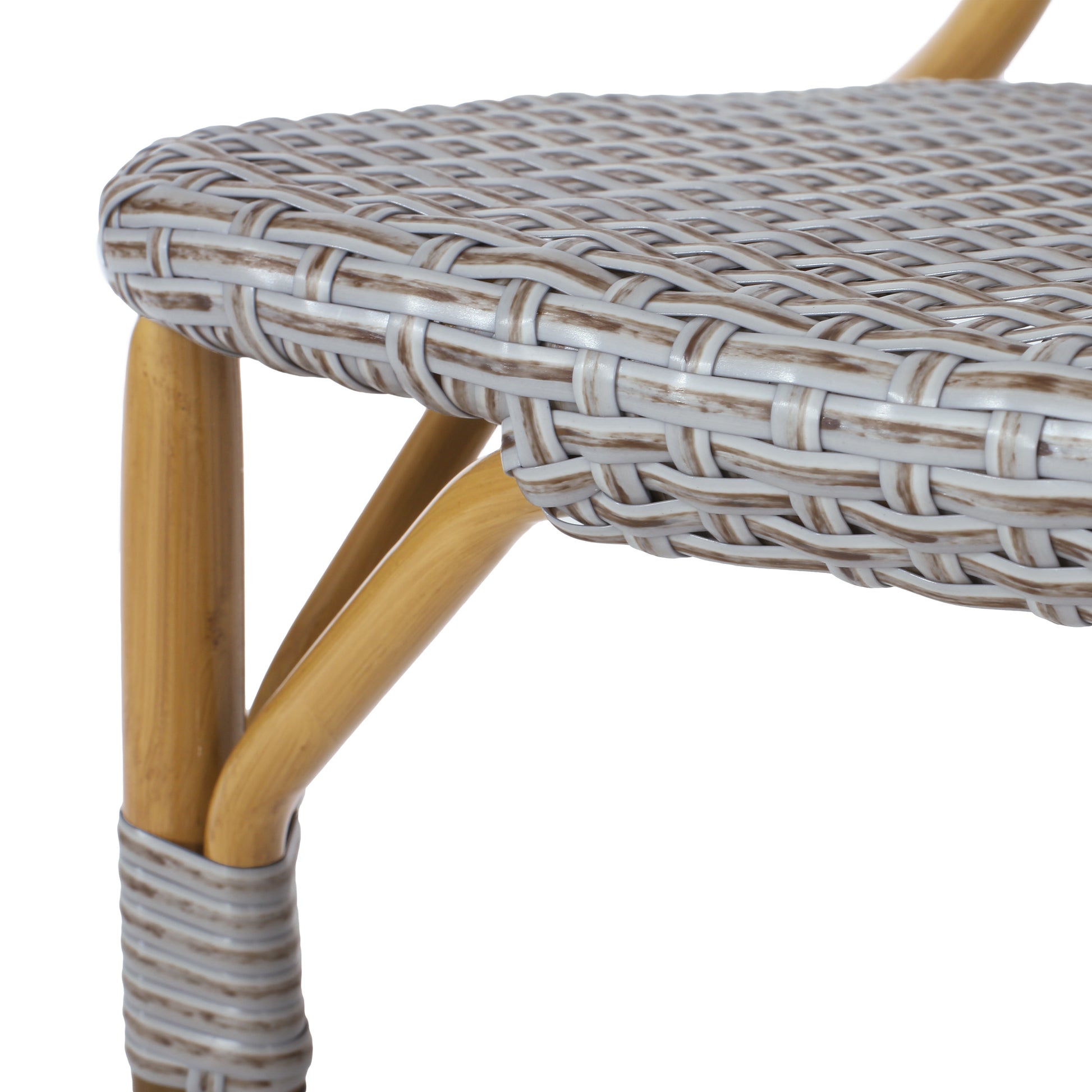 Closeup of a grey rattan cafe chair seat with bamboo legs