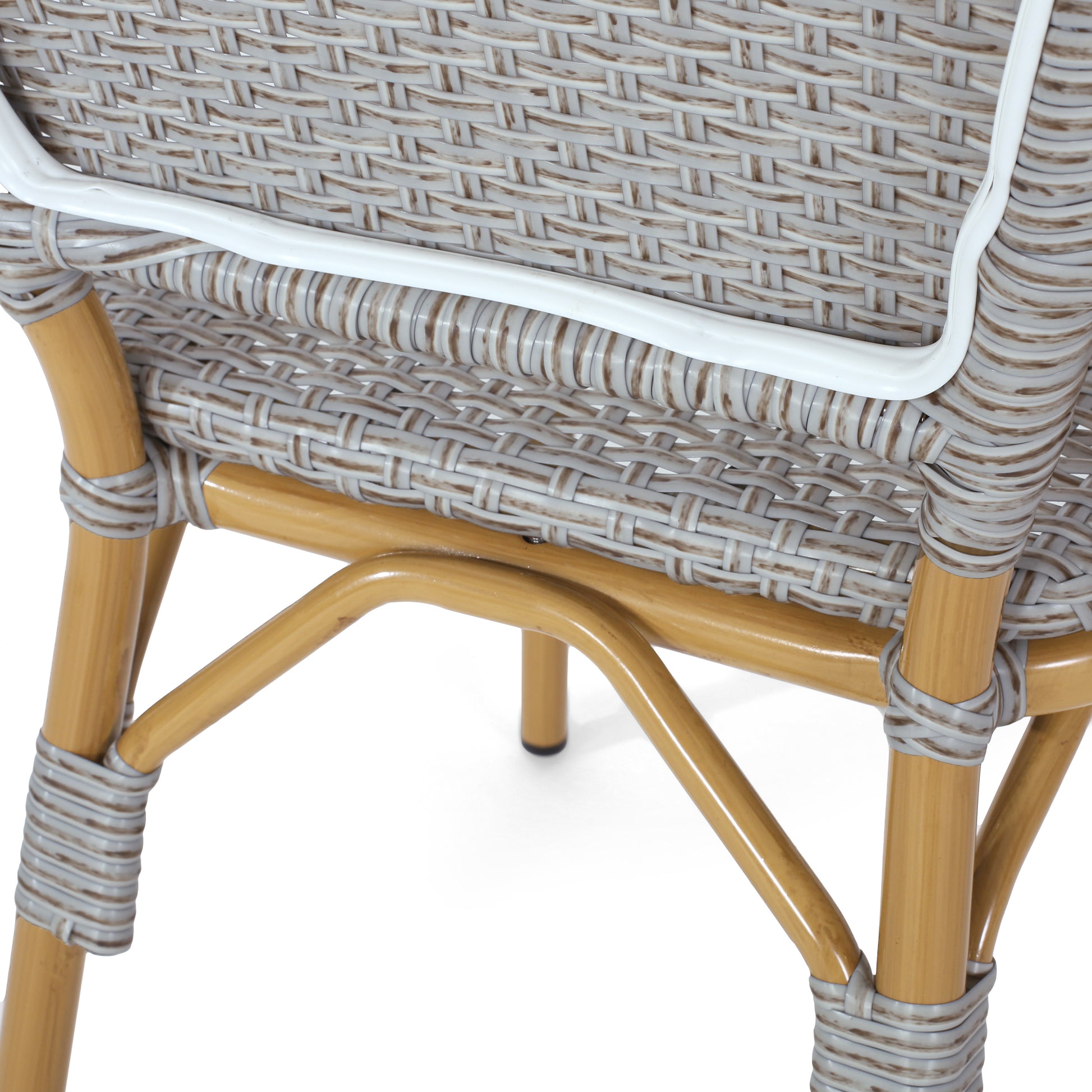 Detail of grey rattan weave chair back with golden metal frame legs