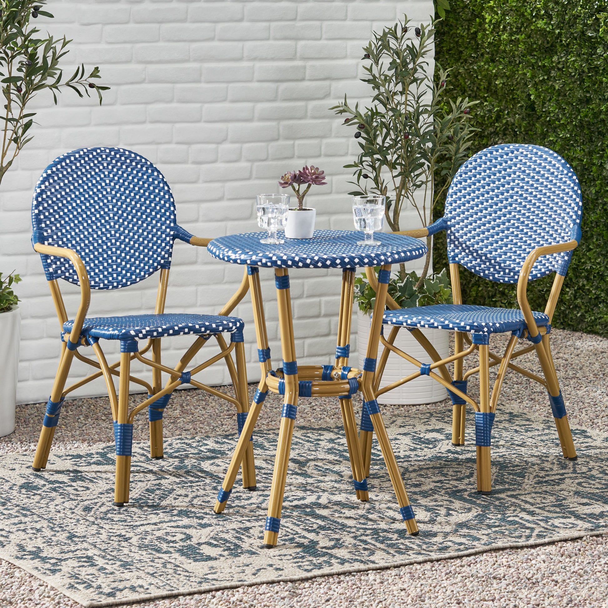 Blue and white woven bistro set with round seats and bamboostyle legs