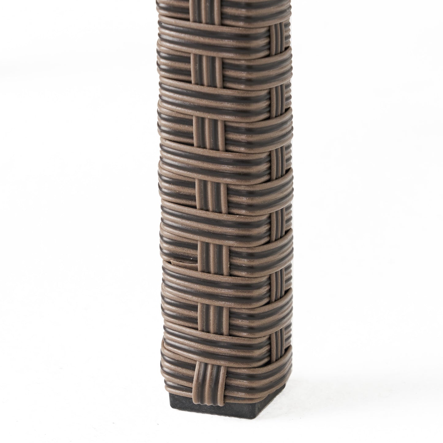 Closeup of brown and black wicker weave on an outdoor chair leg