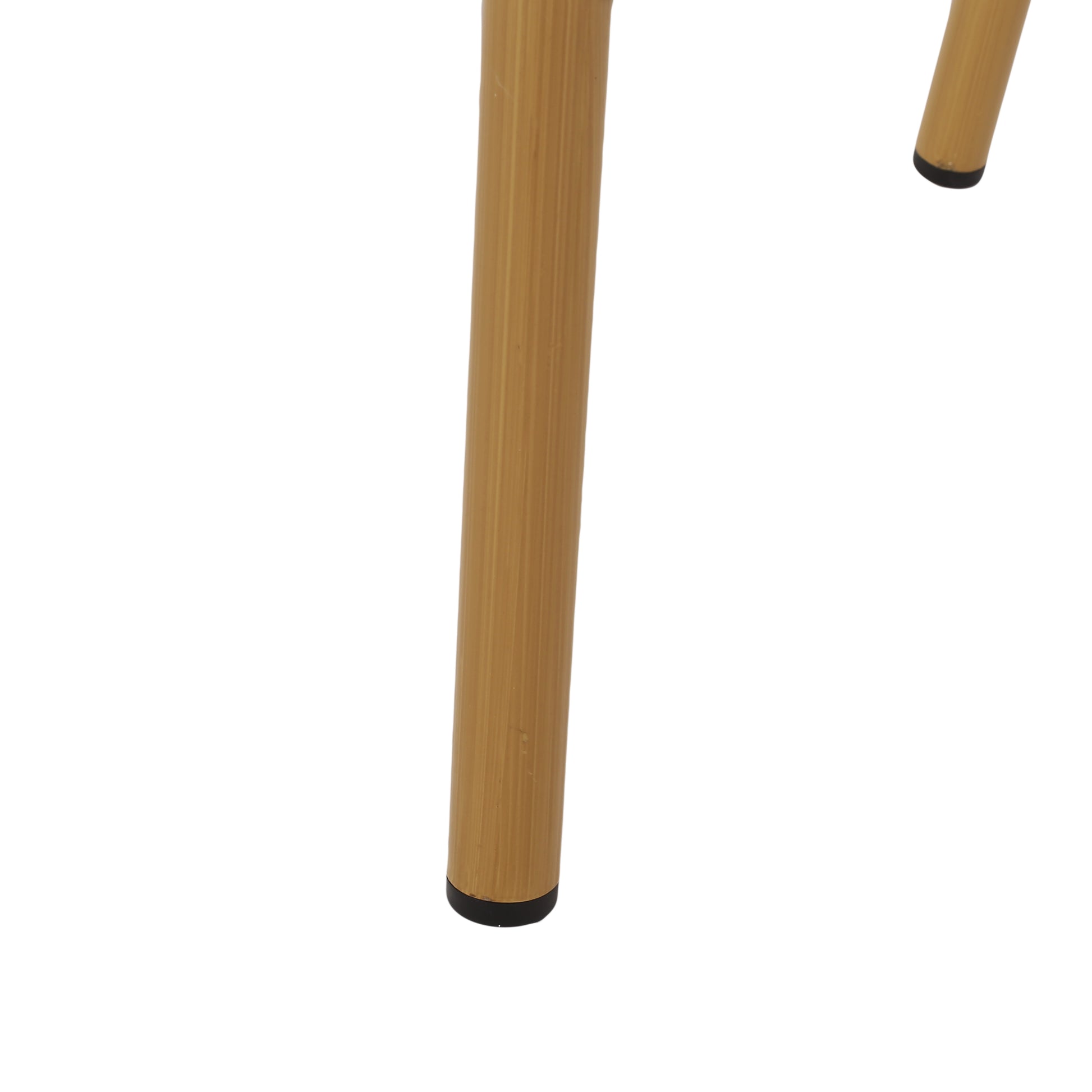 Detail of ribbed brass metal table legs with black feet