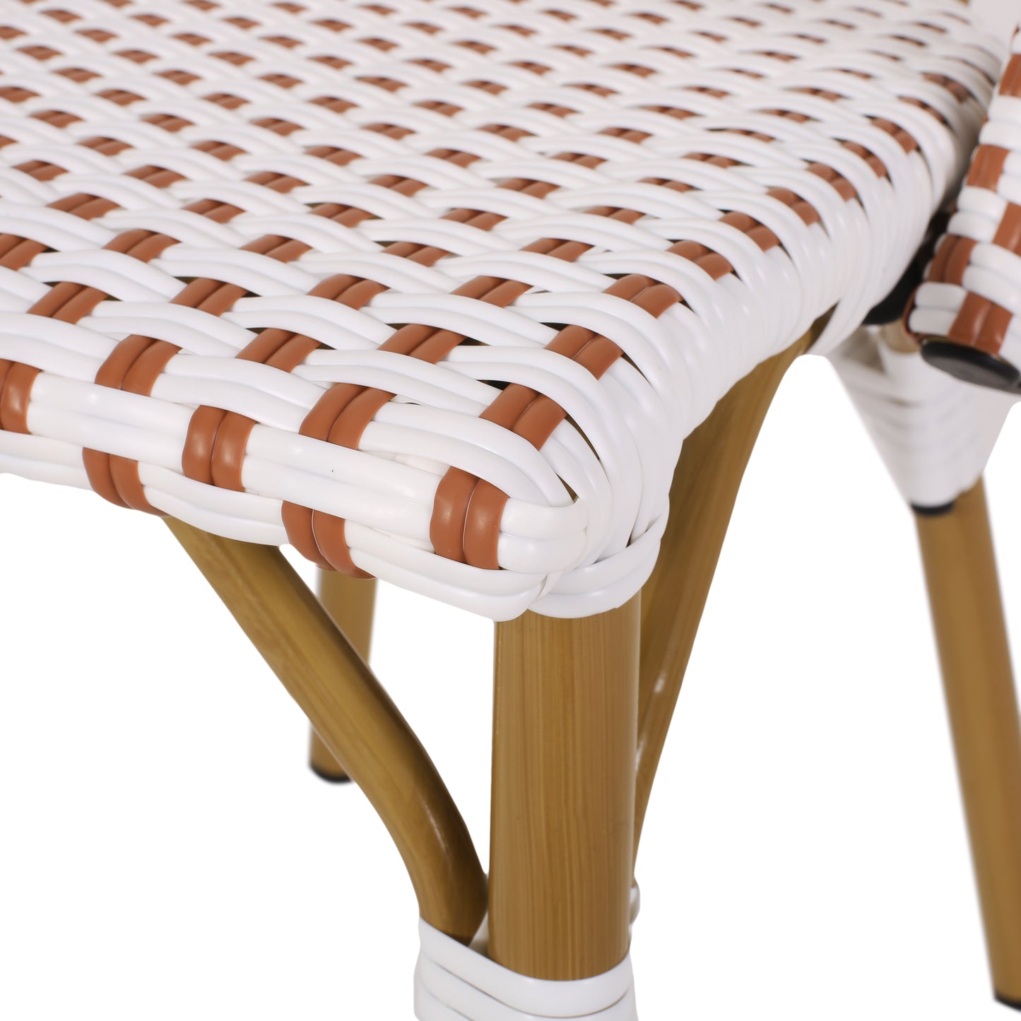 Closeup of a white and brown rattan chair seat with golden legs perfect for outdoor dining
