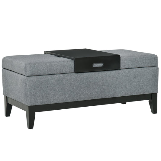 Grey upholstered storage ottoman with removable black tray