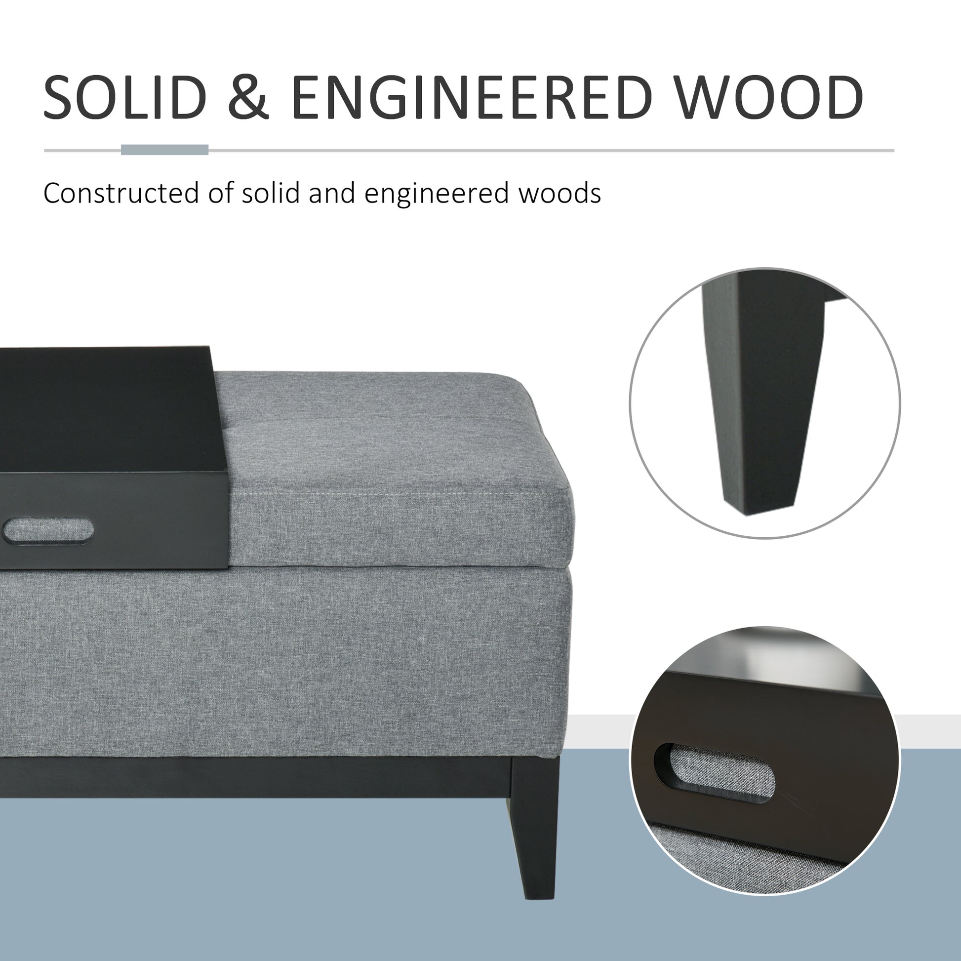 Grey upholstered storage ottoman with removable black tray top and tapered wooden legs