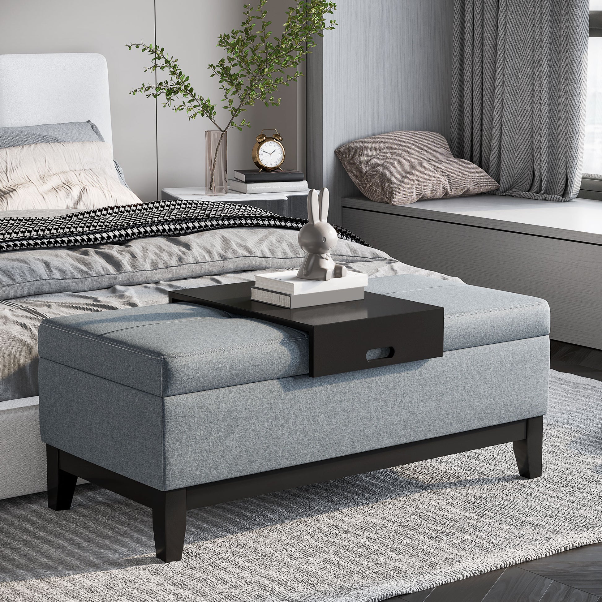 Grey upholstered storage ottoman with black wood legs perfect for bedroom storage needs