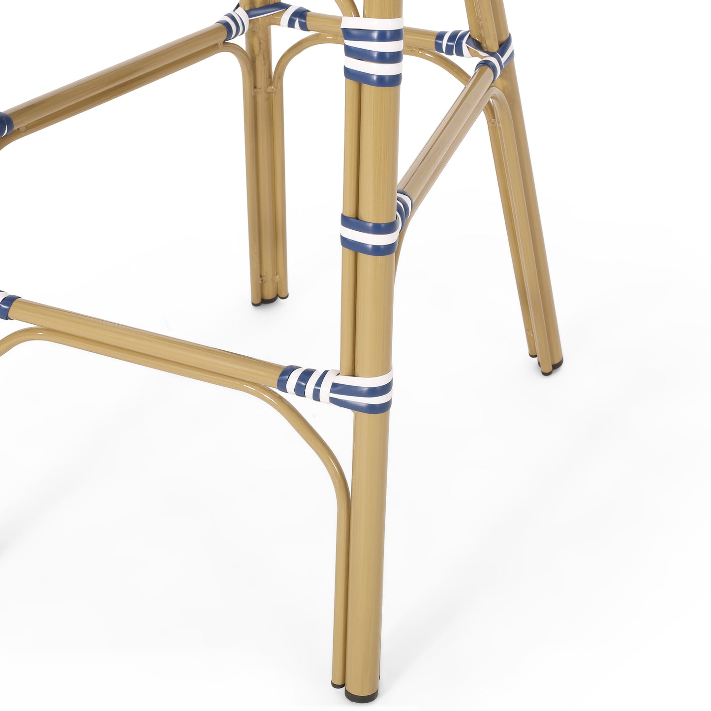 Closeup of tan bamboo chair legs with blue and white stripe accents showcasing outdoor seating style