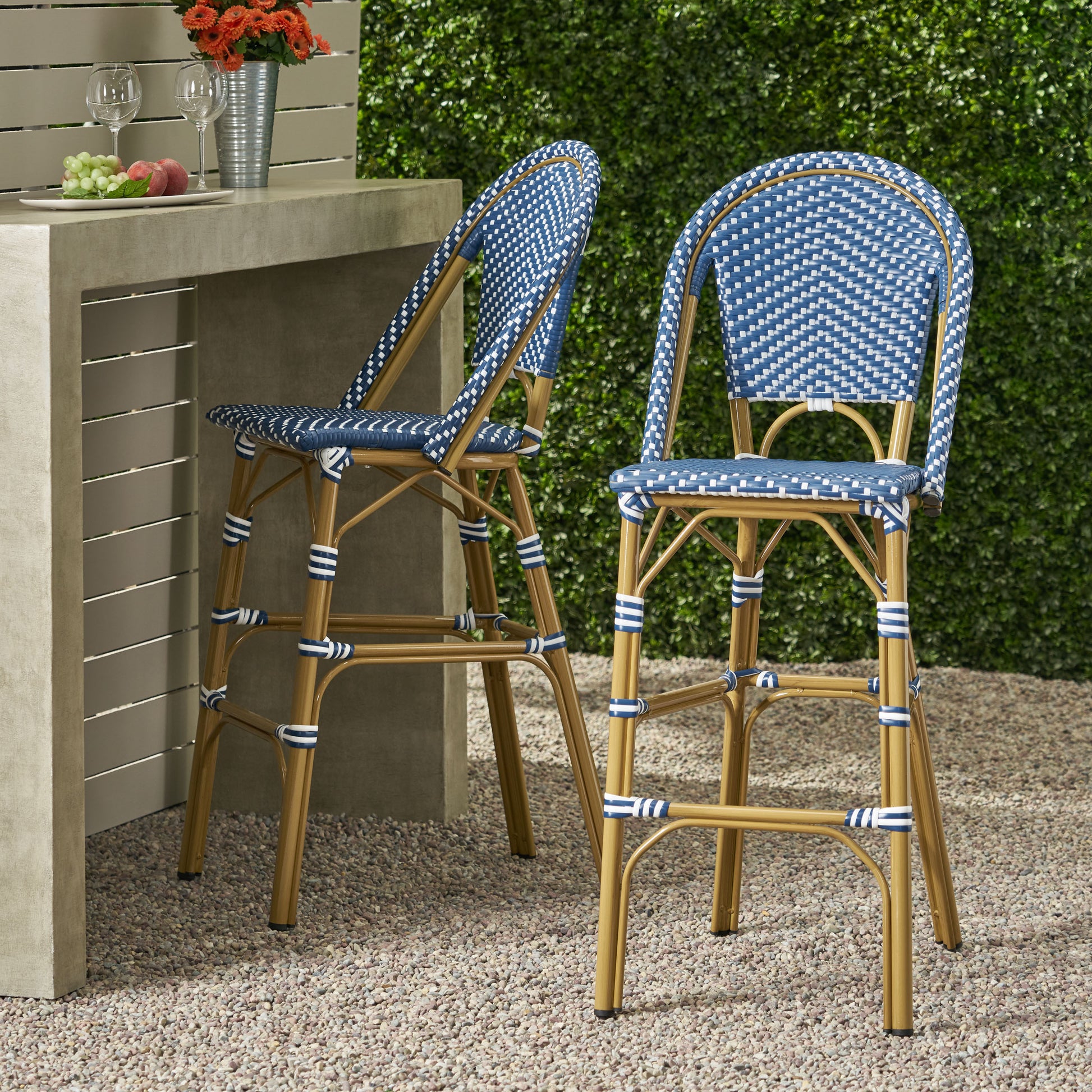 Blue and white checkered wicker bar stool with gold legs and striped detailing