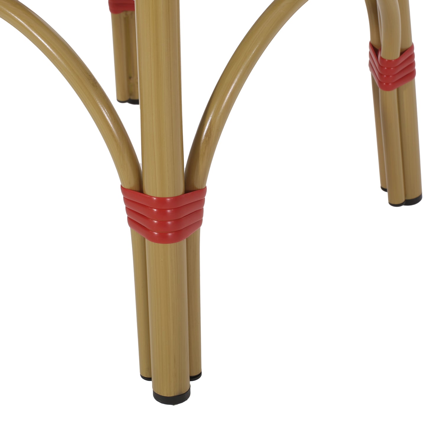 Closeup of tan rattan chair legs with red bands
