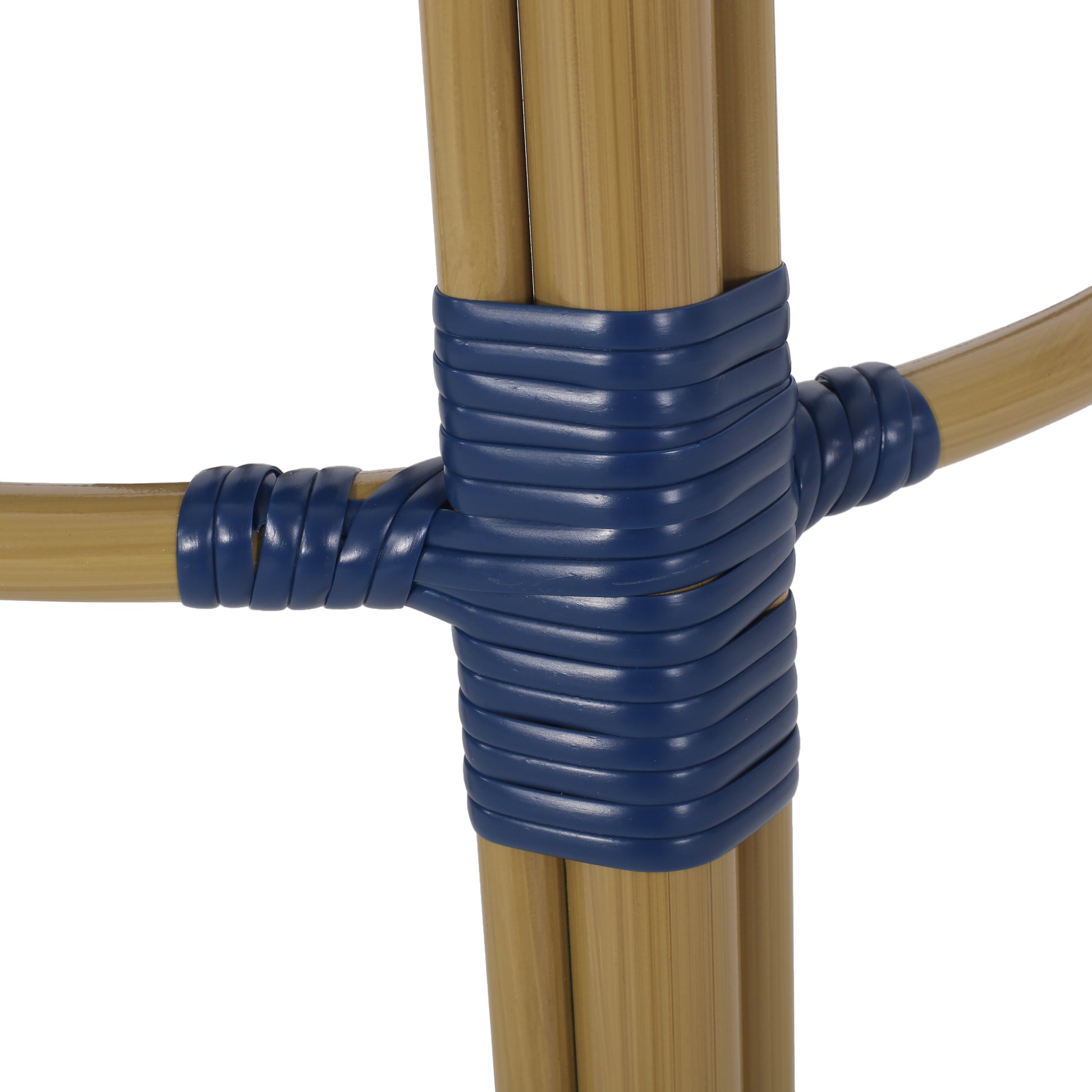 Close up of natural bamboo frame with blue woven detail on an outdoor chair
