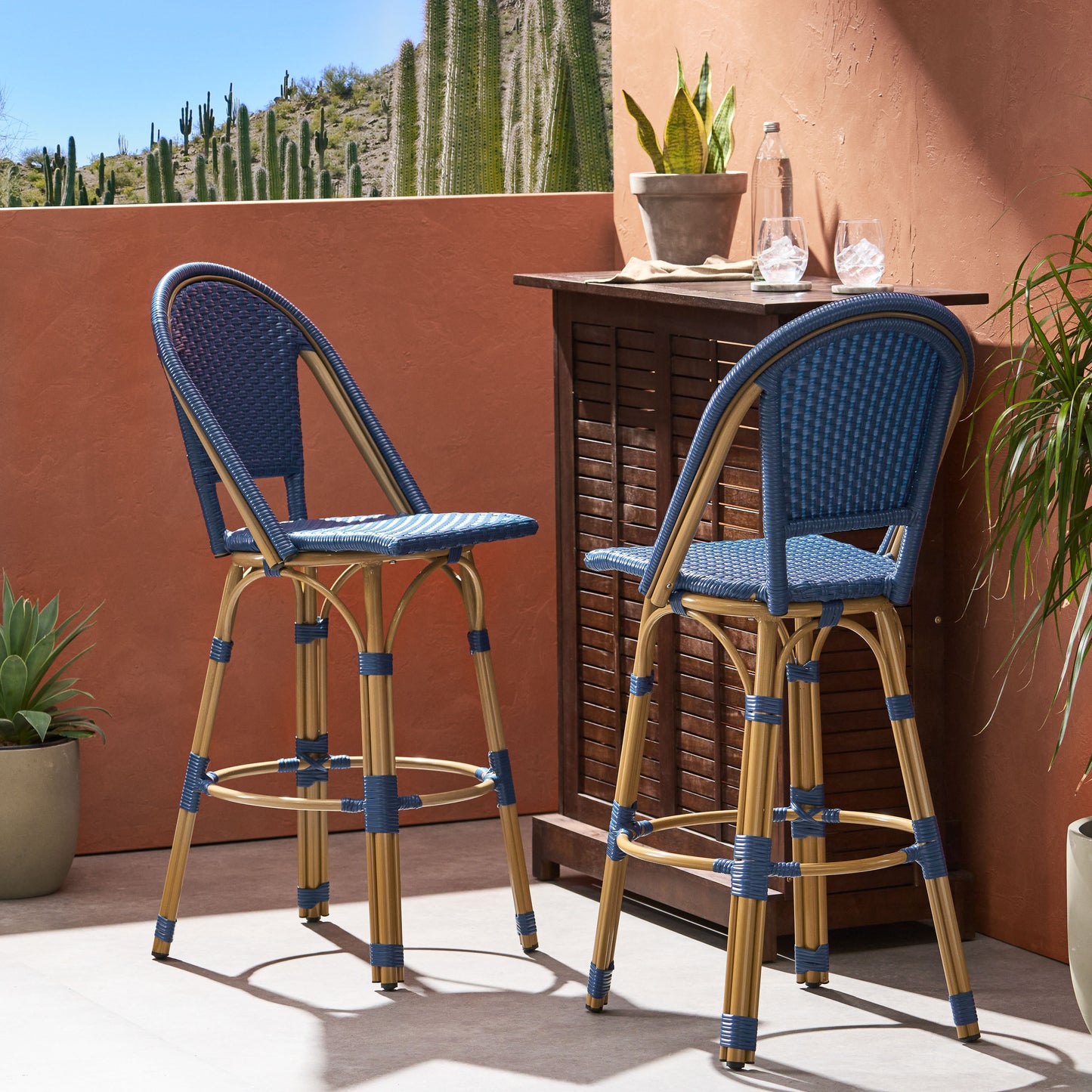 Two blue wicker bar stools with bamboo frames perfect for outdoor entertaining