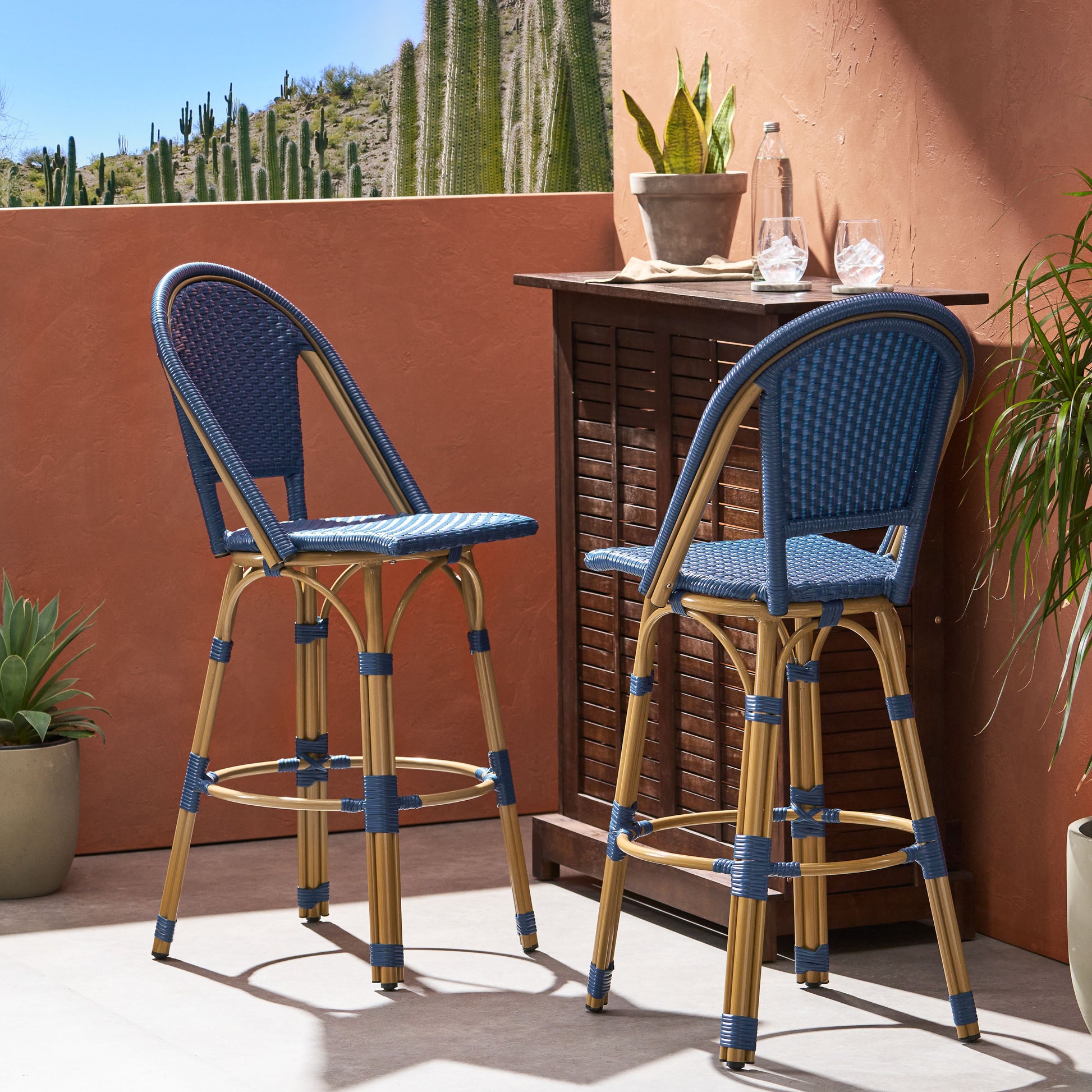Two blue wicker bar stools with bamboo frames perfect for outdoor entertaining