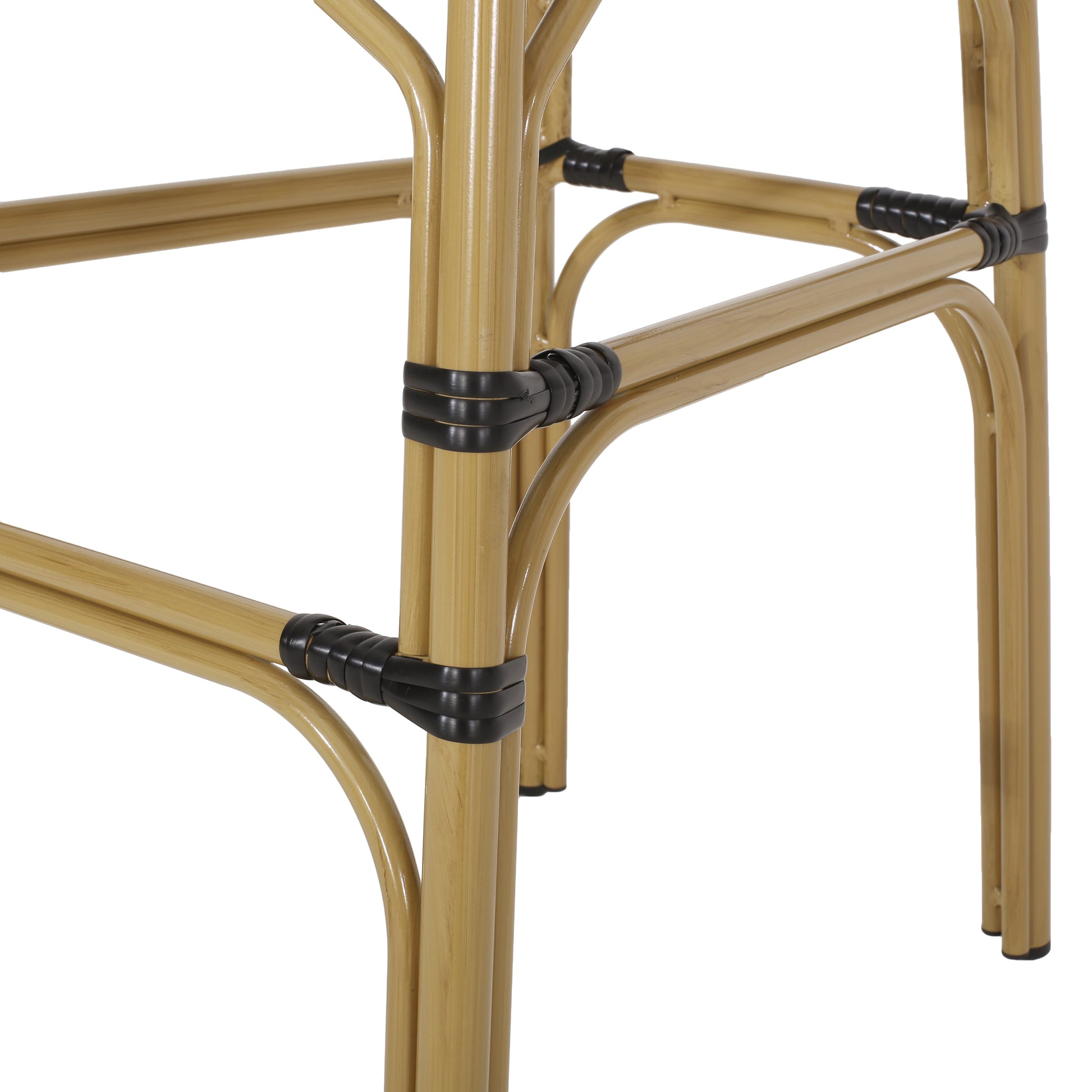 Closeup of natural rattan chair legs with black binding detail modern design