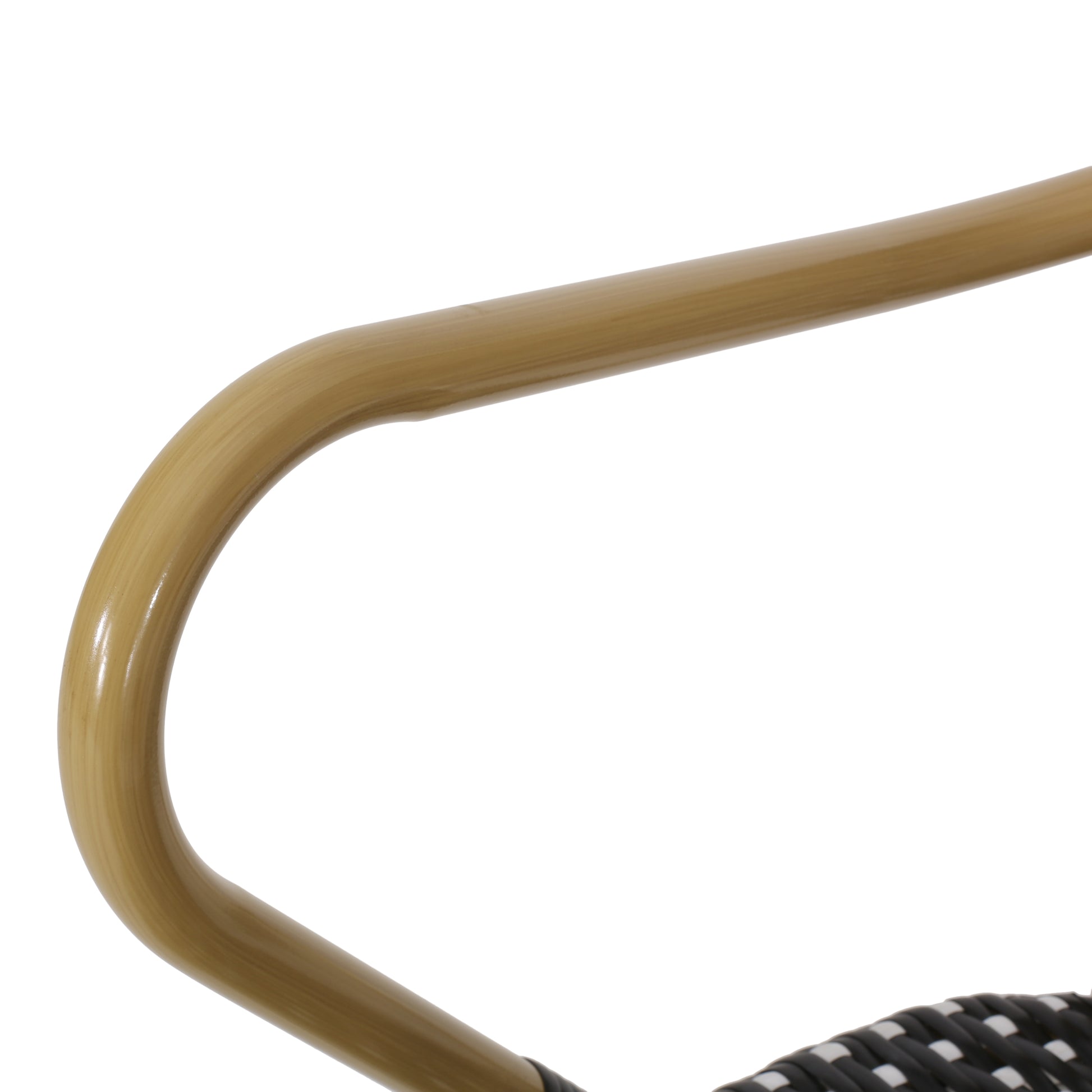 Light brown curved armrest of a wicker patio chair designed for outdoor seating