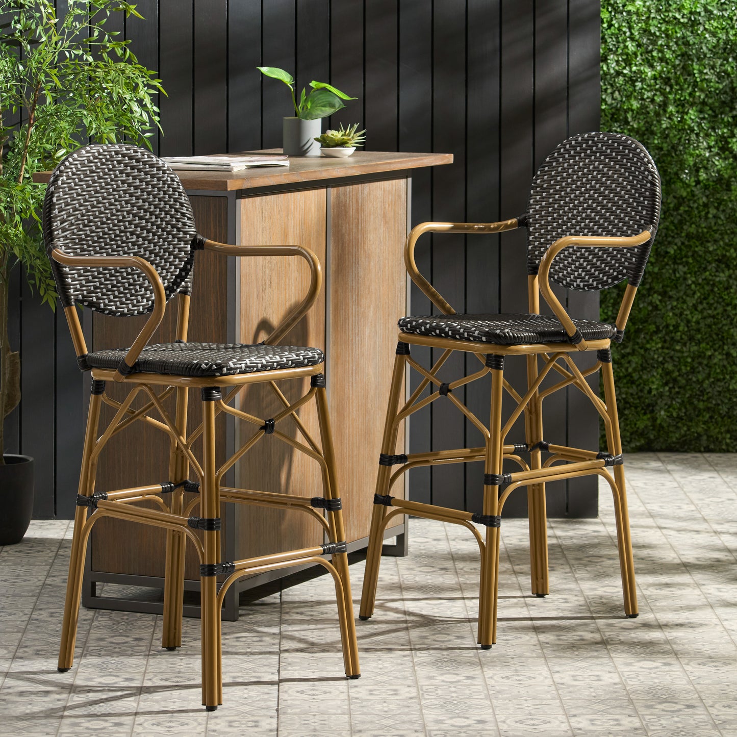 Two dark wicker bar stools with bamboostyle frames and curved arms ideal for outdoor patios