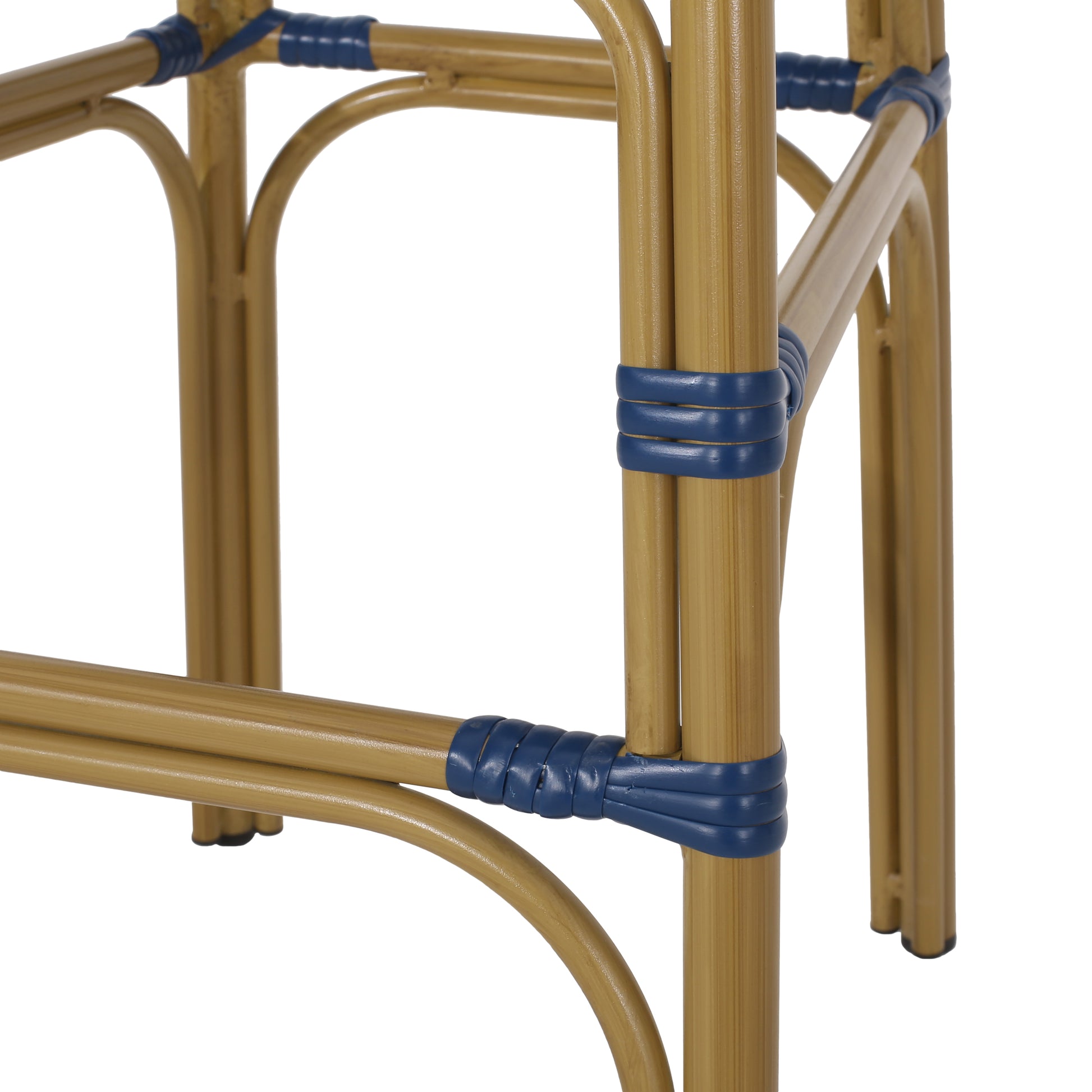 Closeup of gold metal cafe chair legs with navy blue rattan wrap detail