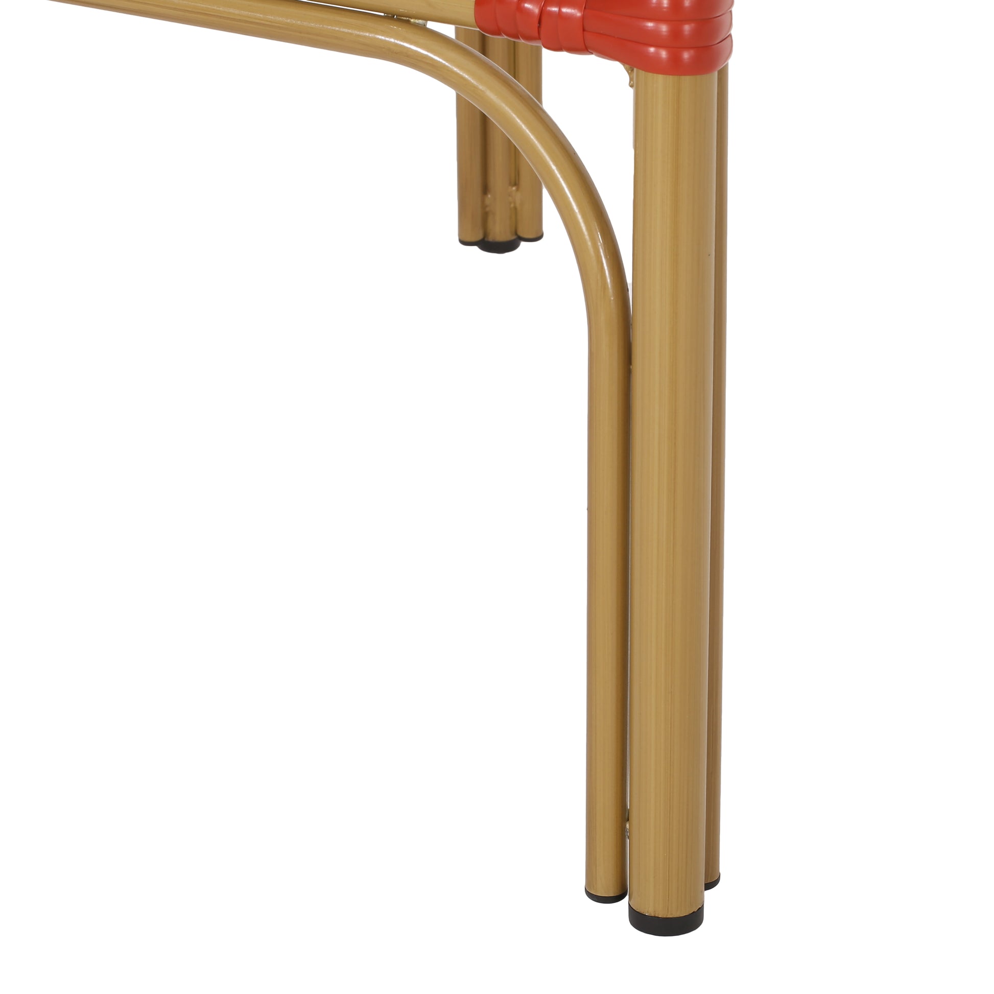 Closeup of golden metal chair legs with red woven accents and black feet