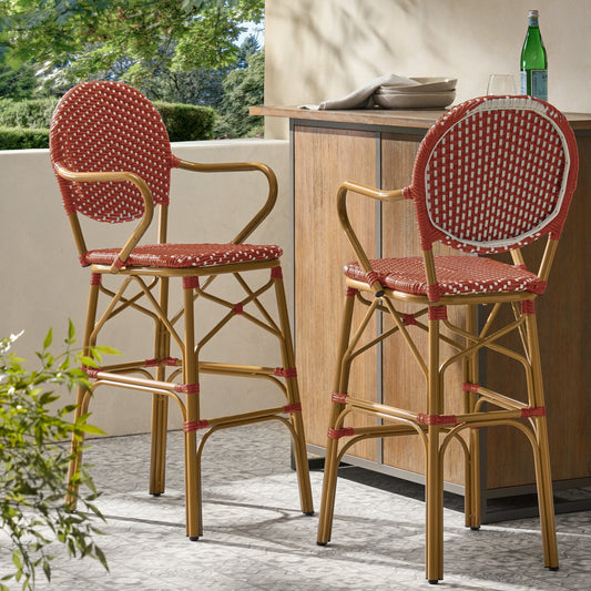 Pair of red and white wicker bar stools with curved arms and bamboo legs