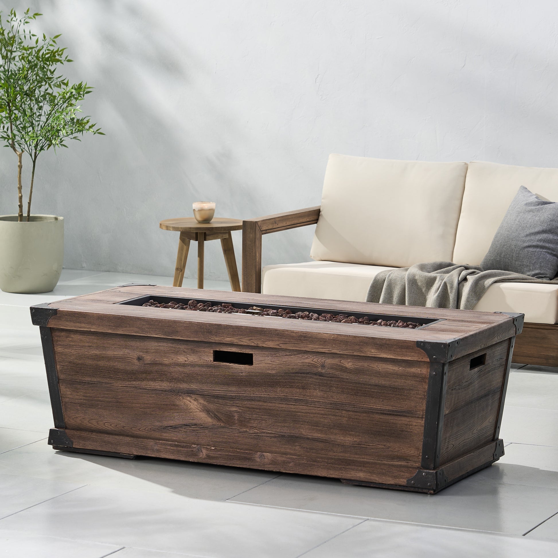 Dark wood patio fire pit table with metal accents perfect for outdoor gatherings