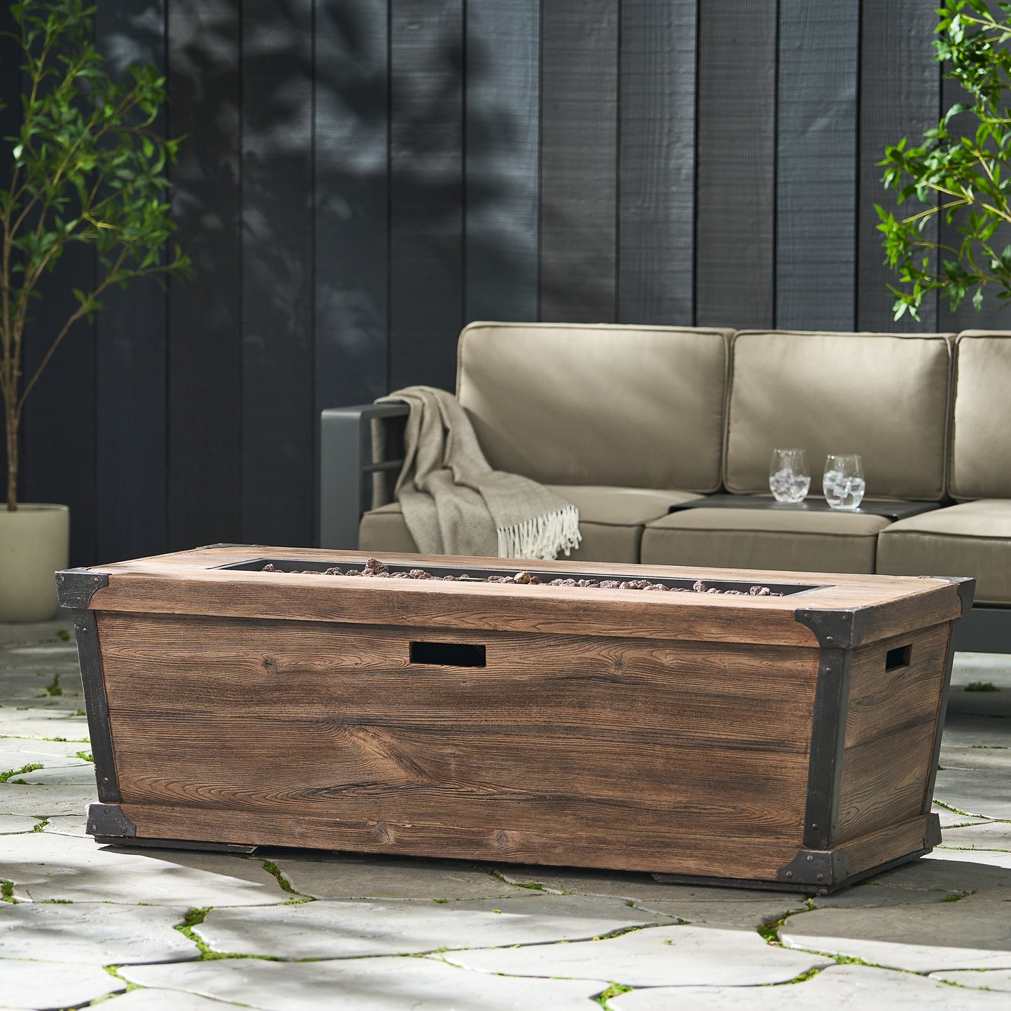 Rustic brown wood gas fire pit table with metal accents for outdoor patio