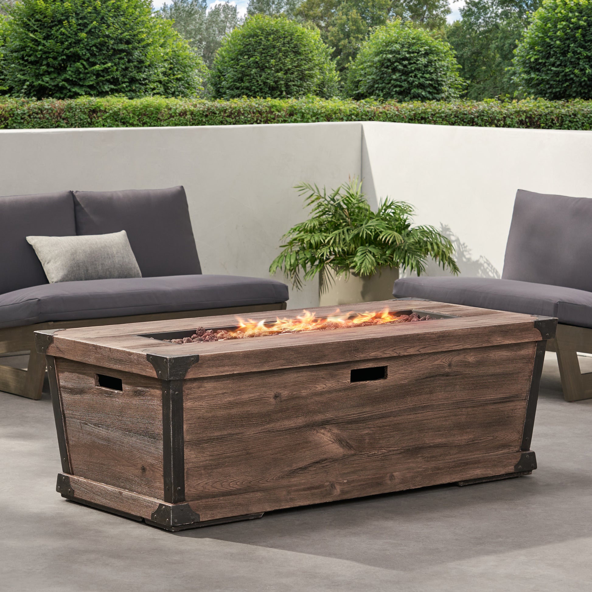Rustic wooden gas fire pit table with dark metal accents and decorative lava rocks  characters