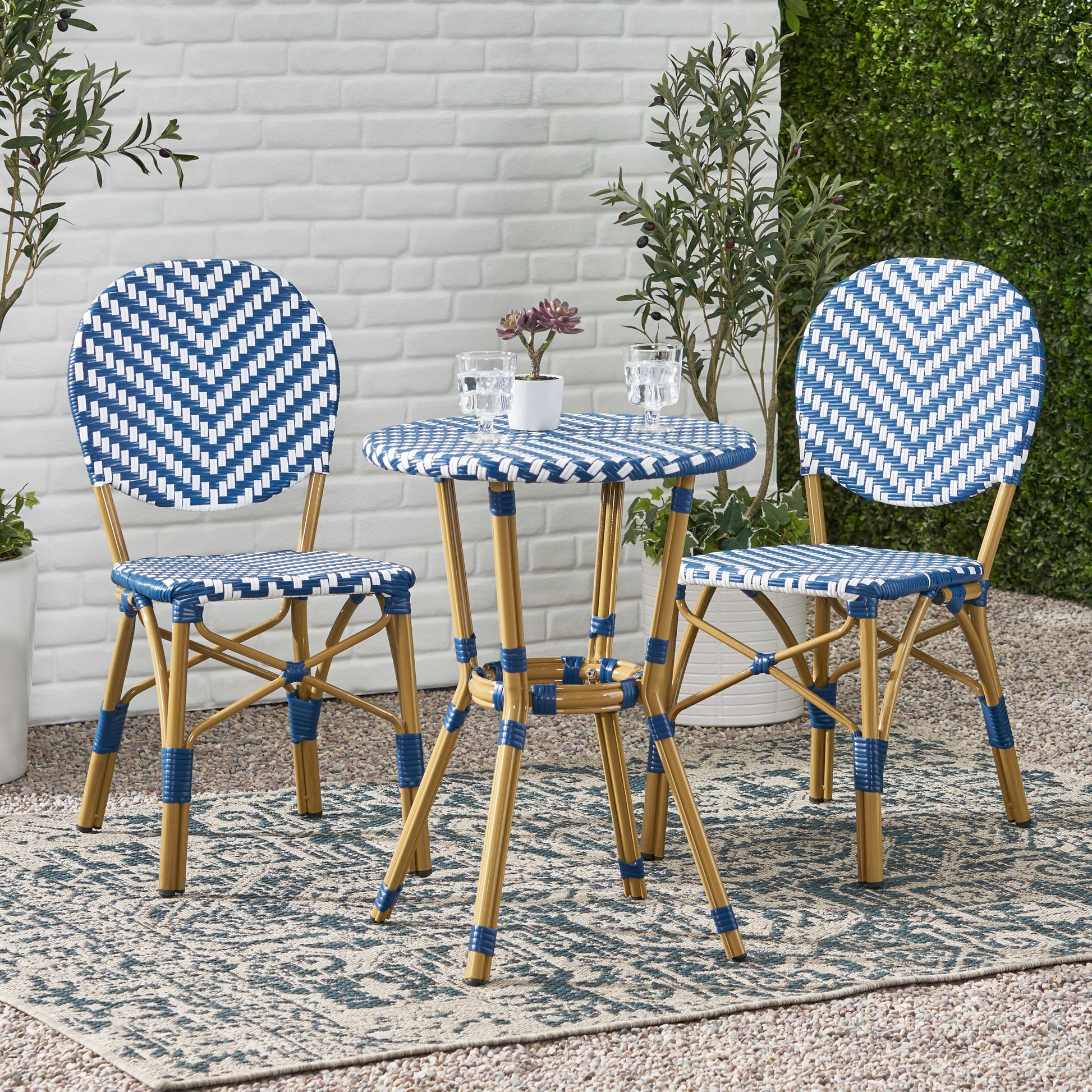 Blue and white rattan bistro set with a round table and two chairs perfect for outdoor seating