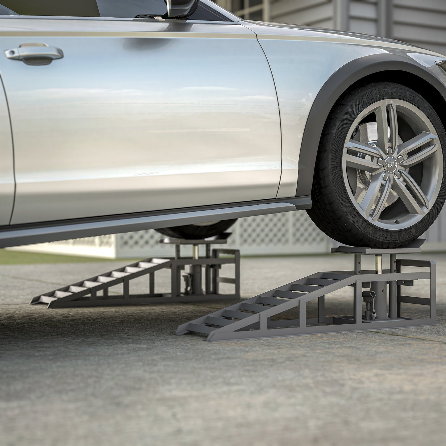 Heavyduty steel car ramps lifting a silver Audi for maintenance